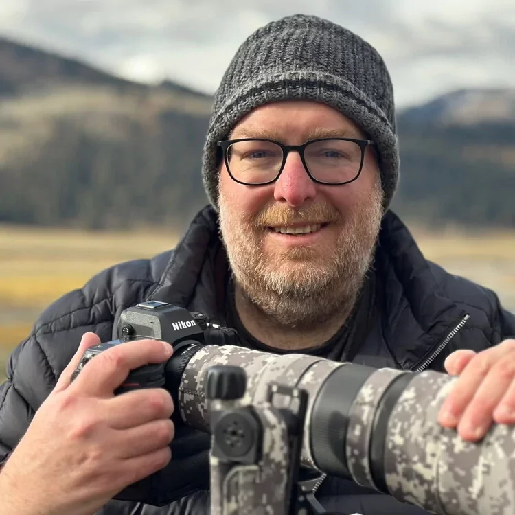 Image of Dave Miller in the Yellowstone with camera