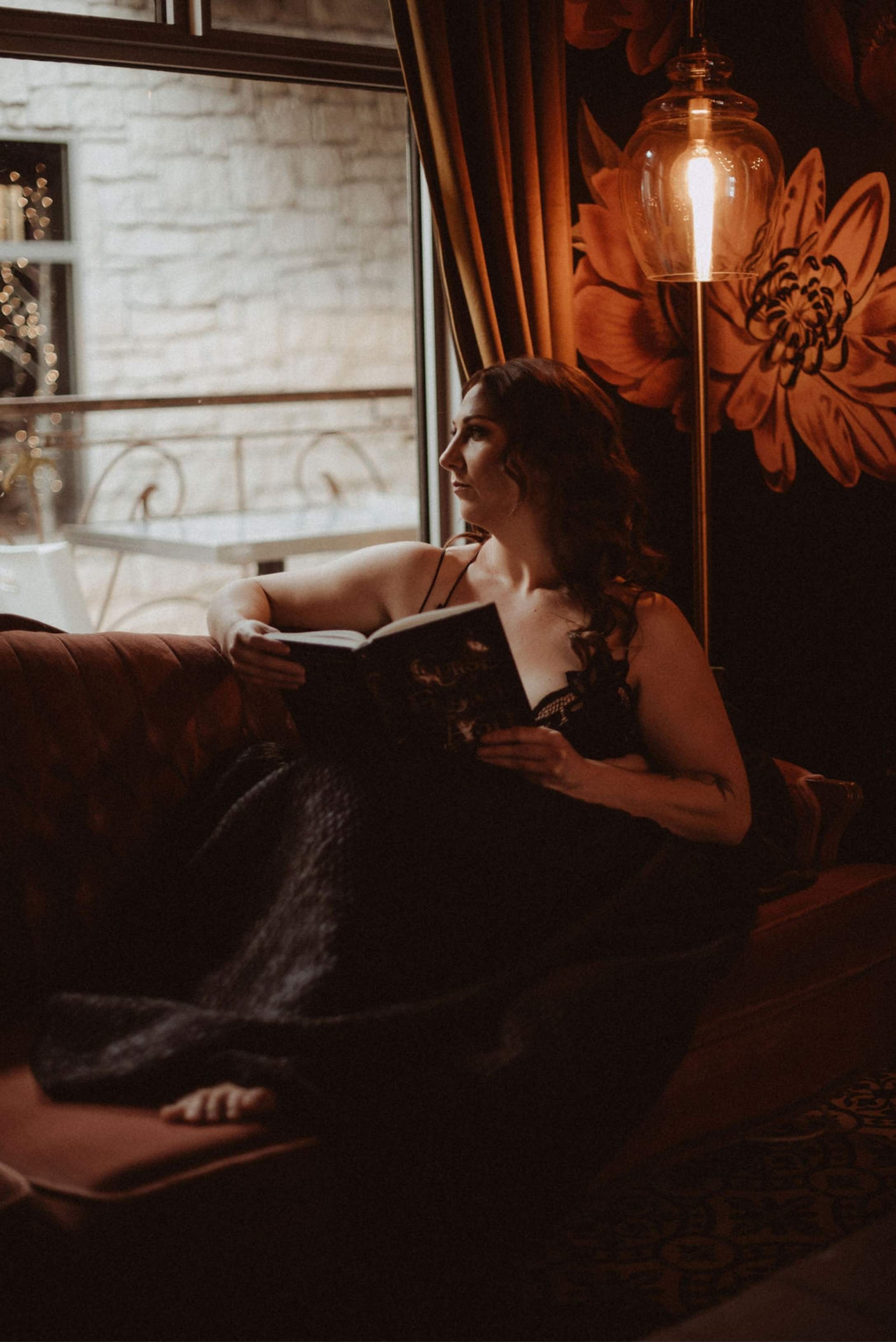 Portrait of dark fantasy romance author, Kaitlyn L. Hill, bathed in moody, natural light