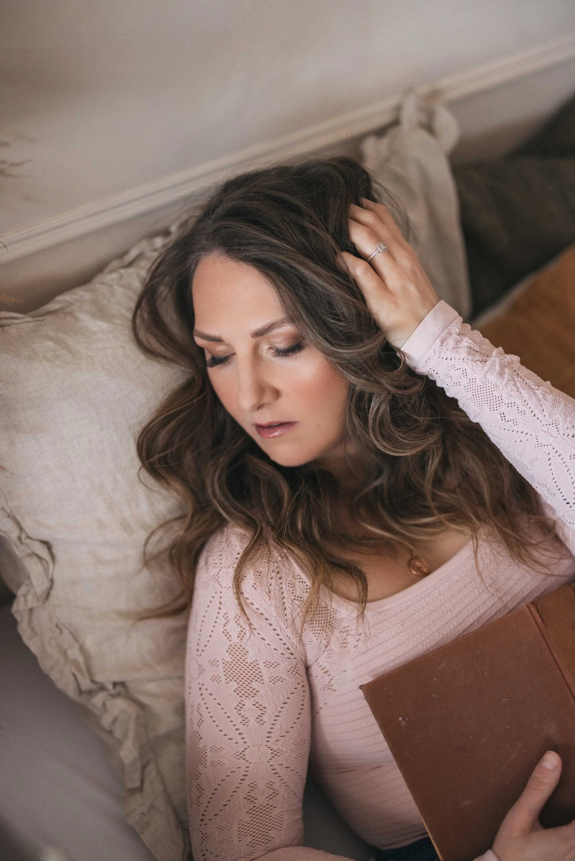 Portrait of dark fantasy romance author, Kaitlyn L. Hill, bathed in soft, natural light