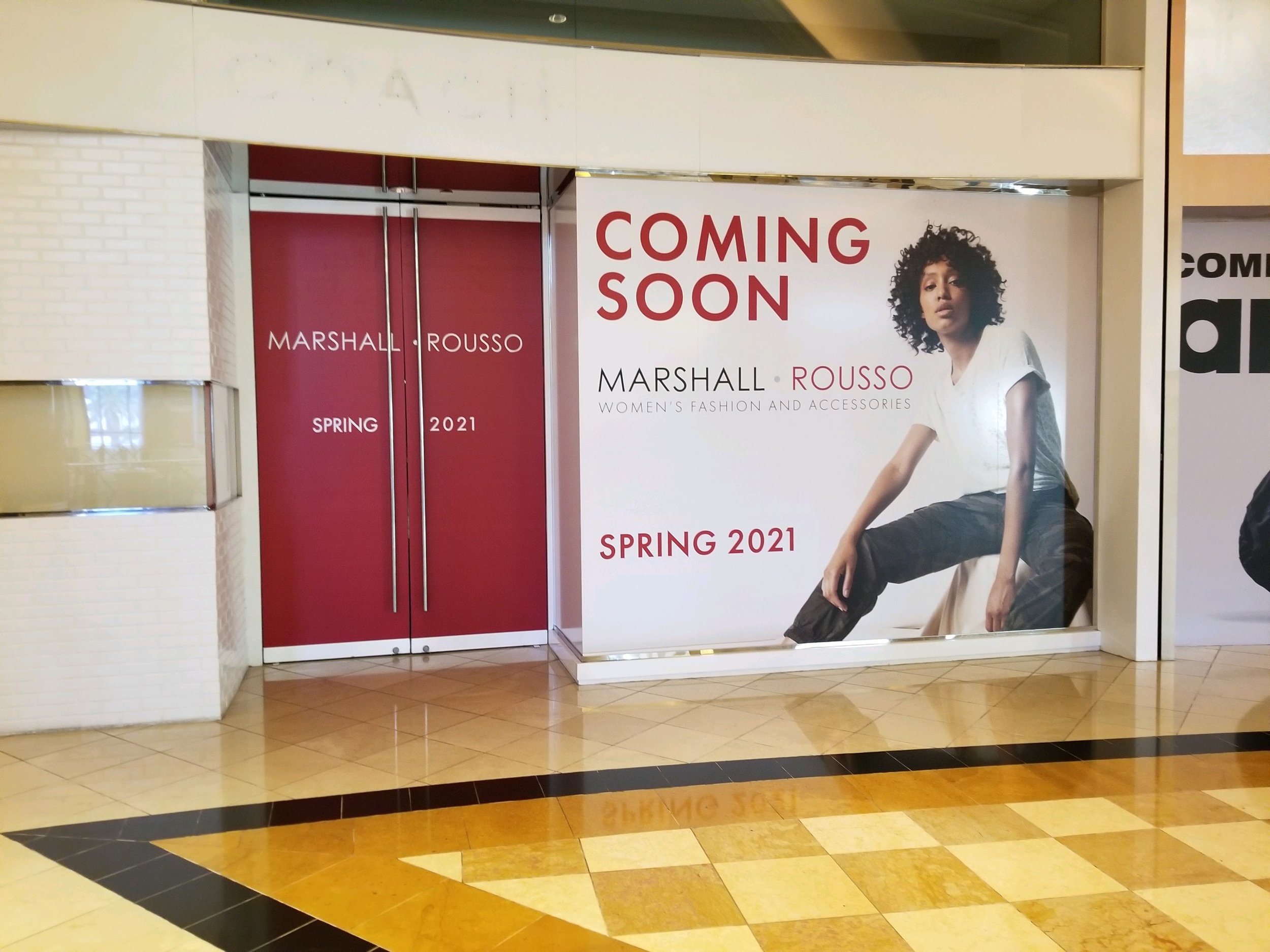 Marshall Rousso mall window graphic featuring a Coming Soon announcement