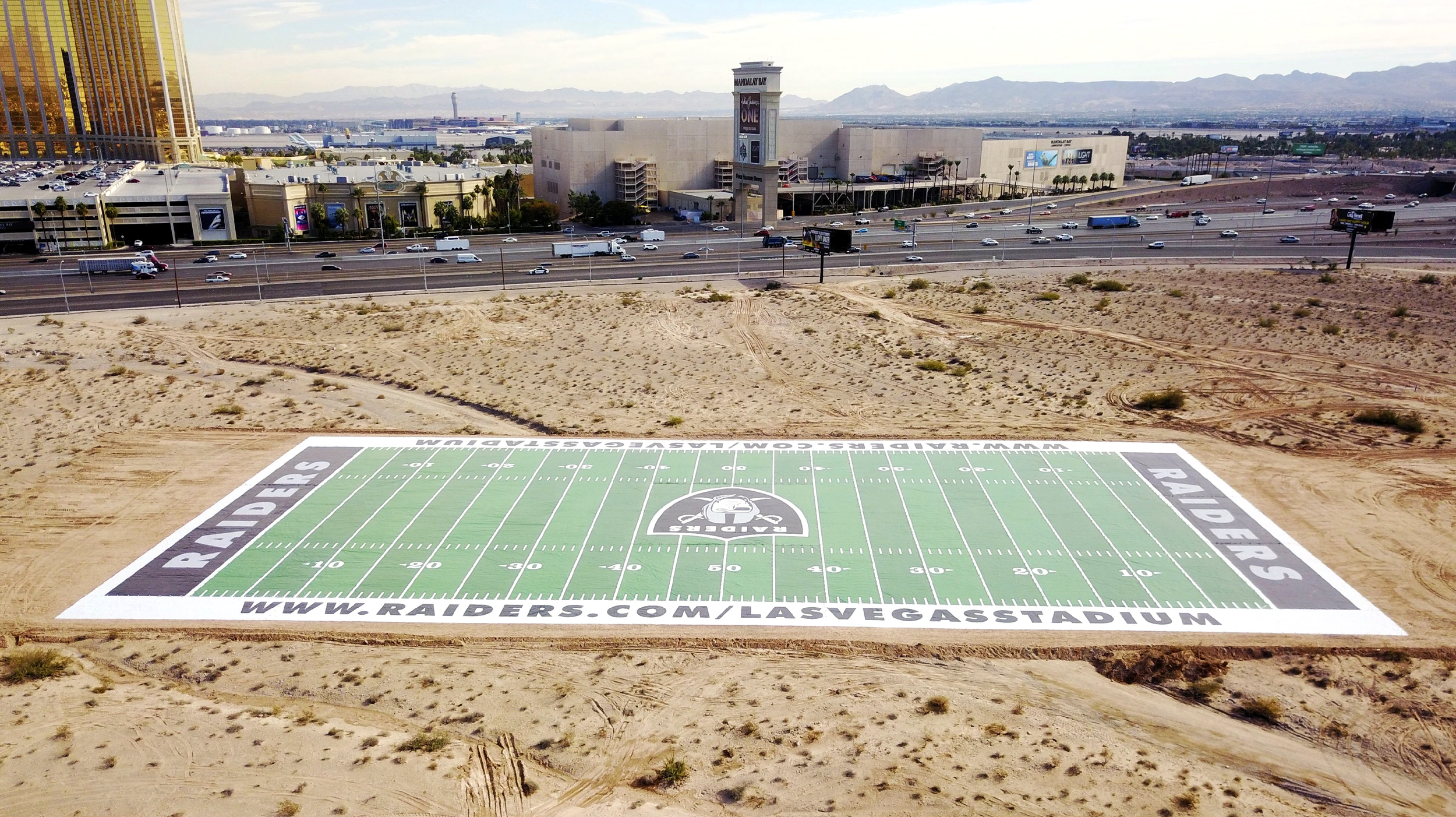 Massive Raiders-branded field banner installed in the Las Vegas desert to promote the new stadium.