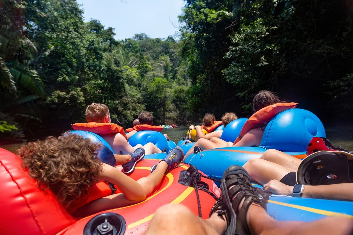  Group of kids in tubes on the river. 