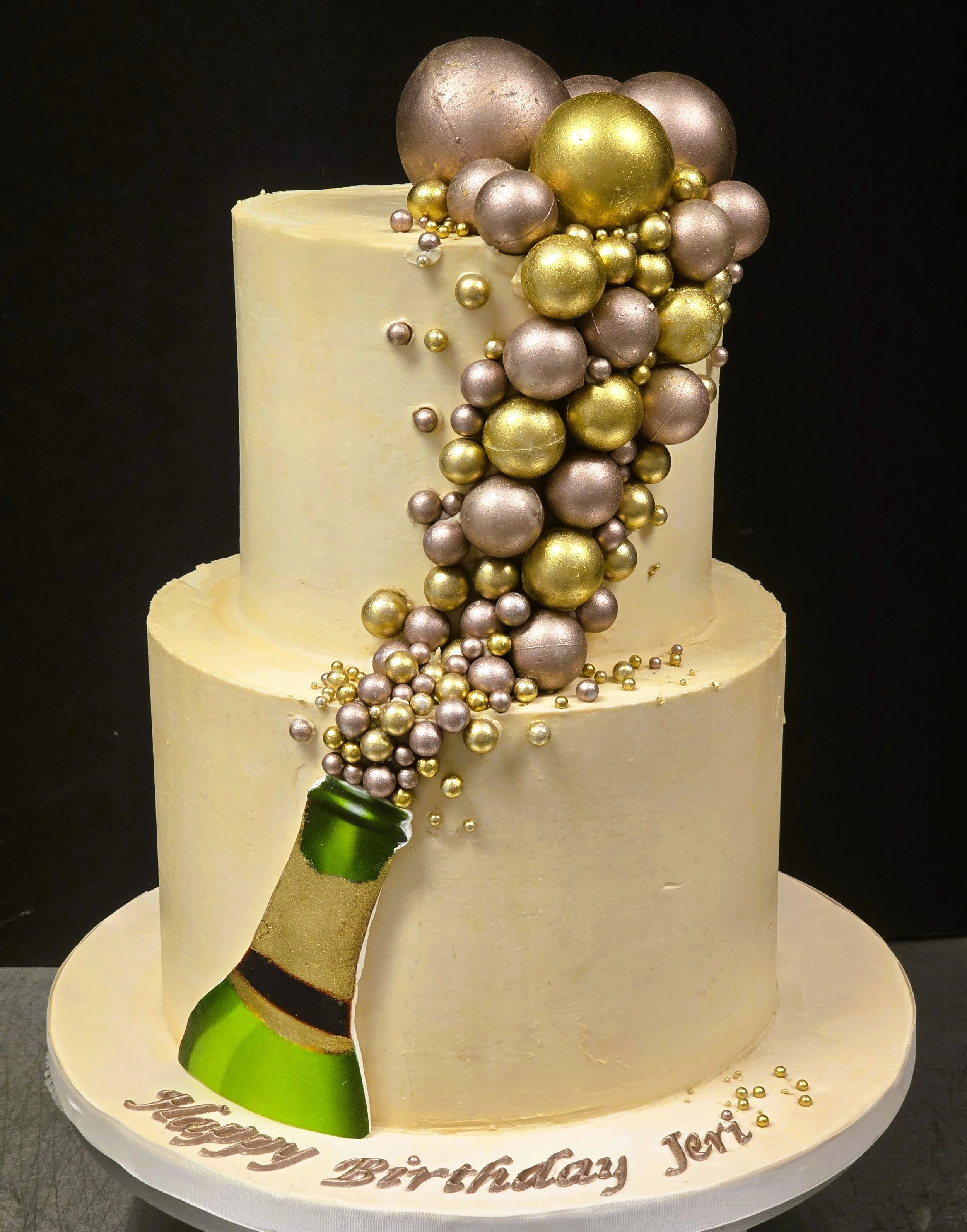 Birthday cake in buttercream Champagne bottle with many chocolate bubbles floating up.jpg