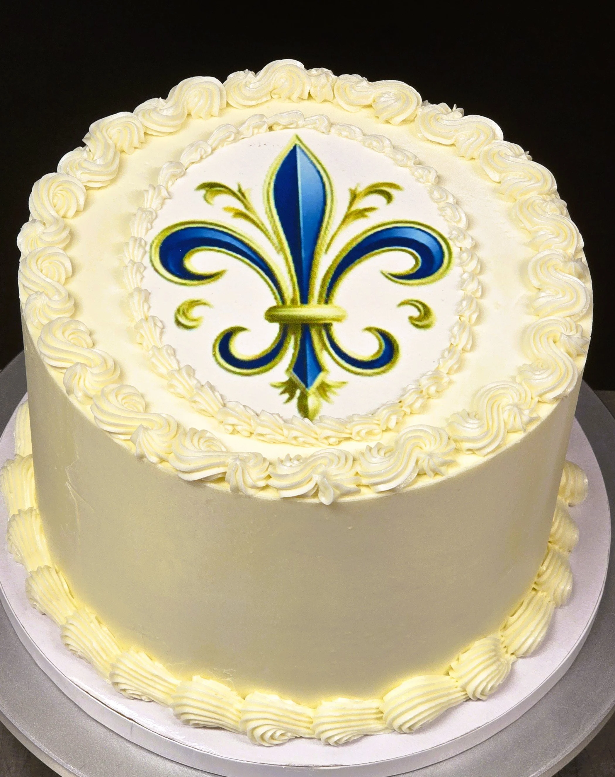 Birthday cake buttercream with printed fleur-de-lis blue and golden.jpg
