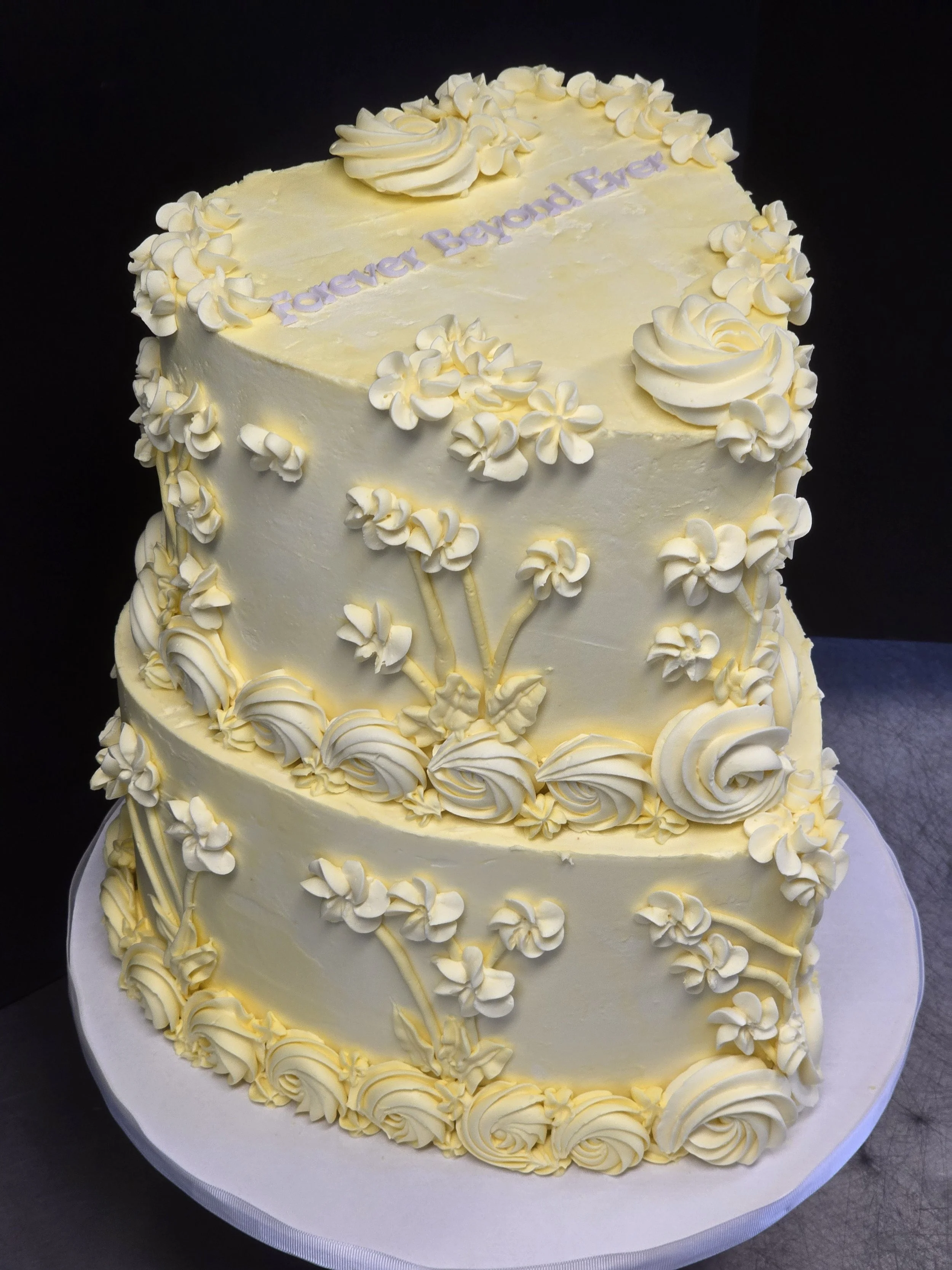 This heart-shaped cake with lovely swirls and flowers, all in the same color, creates a beautiful pattern that is rich and elegant. No topper, no distractions, just a three-word promise of love. 