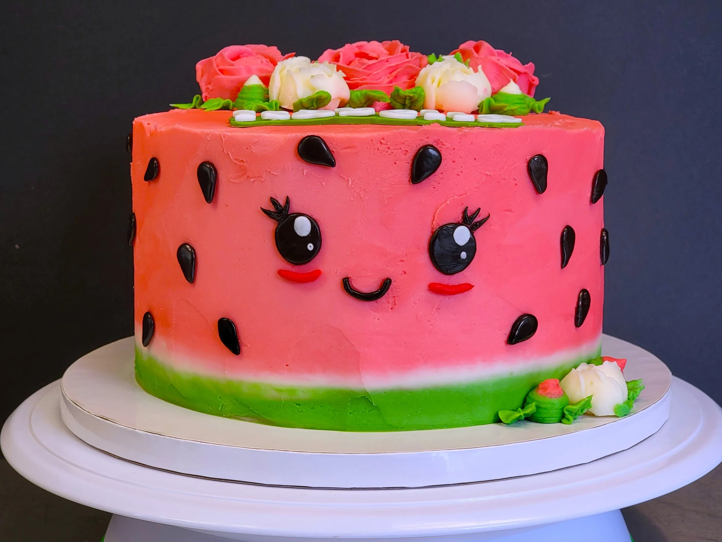 Birthday cake shaped like a watermelon smiling face