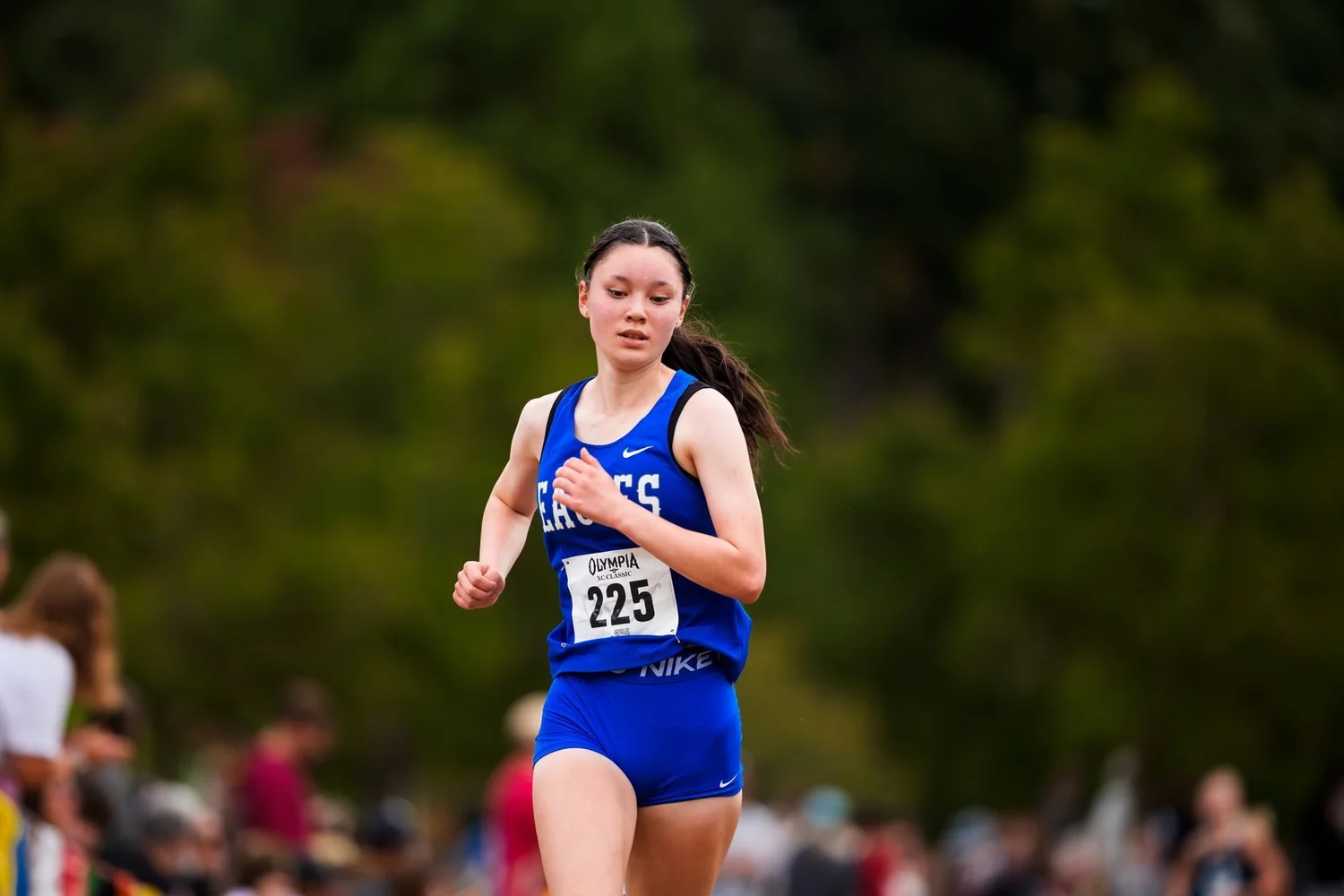Cross-country runner competing on a grassy course