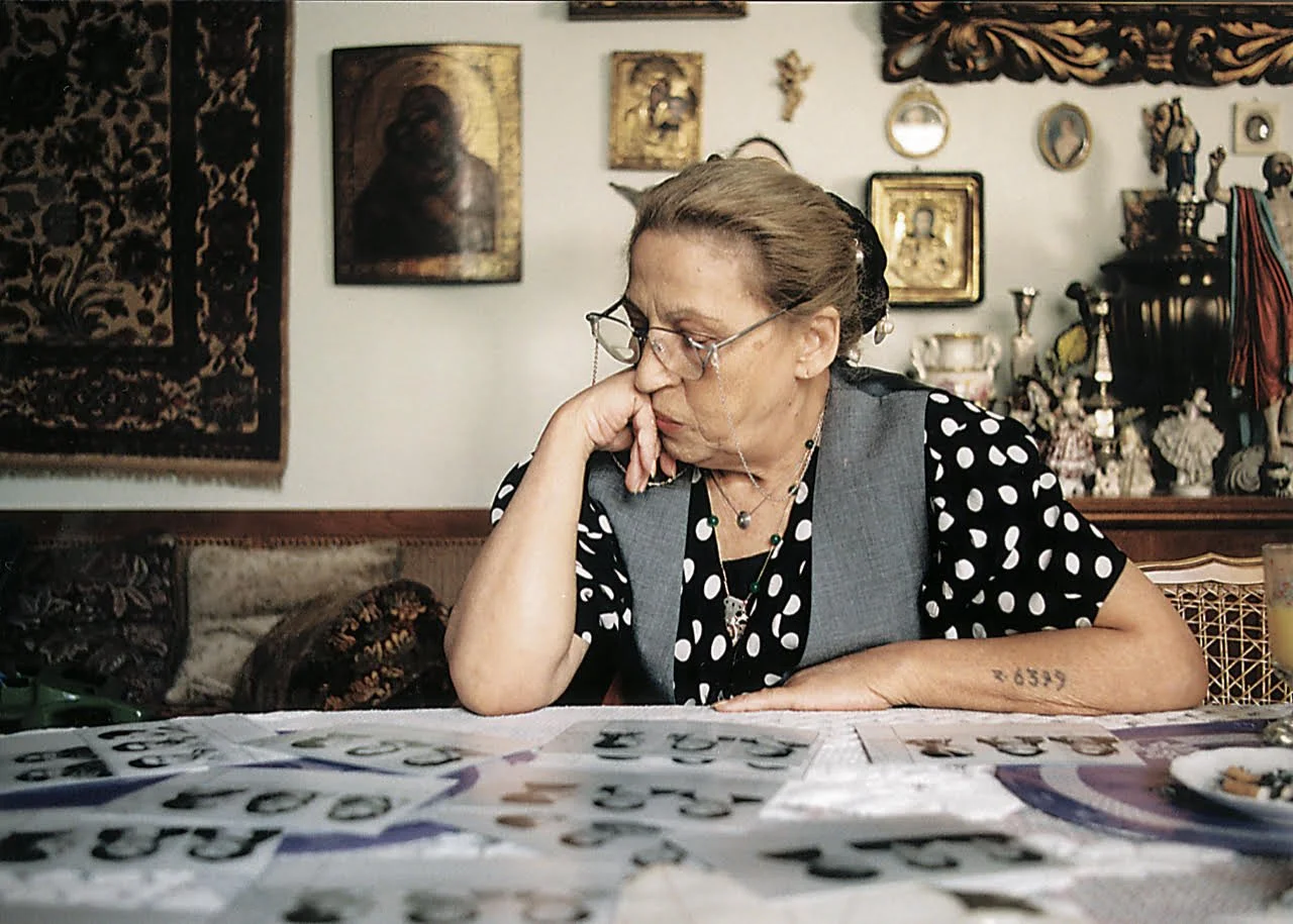  Ceija Stojka in her apartment in 1977 looking at the index cards of her family (Nazi’s racist “special registration).   Courtesy of Navigatorfilm 