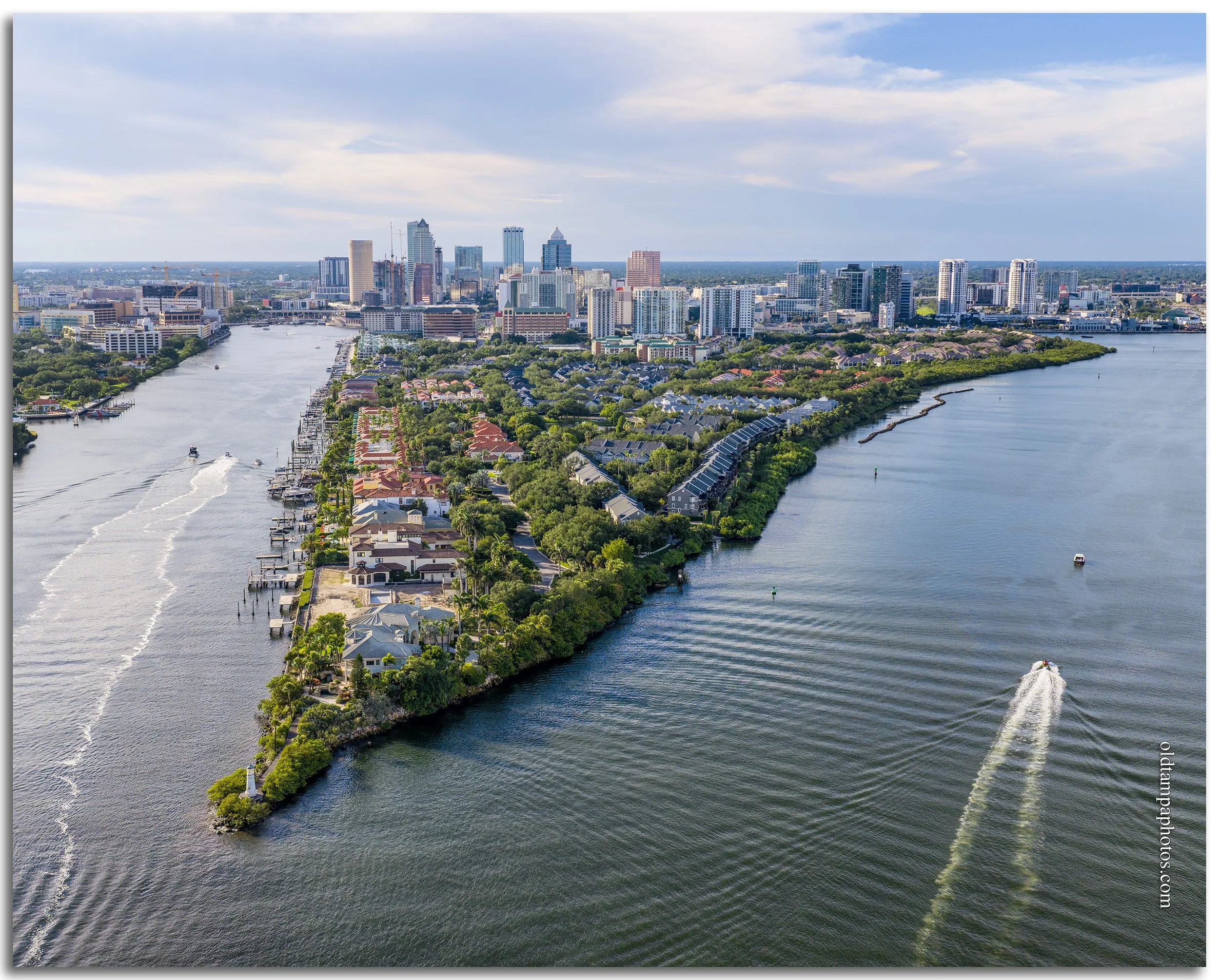 Aerial photograph of Harbor Island from the south in 2026, showcasing Tampa's waterfront skyline, luxury residences, marinas, and the transformation of a former industrial port into a vibrant urban community.