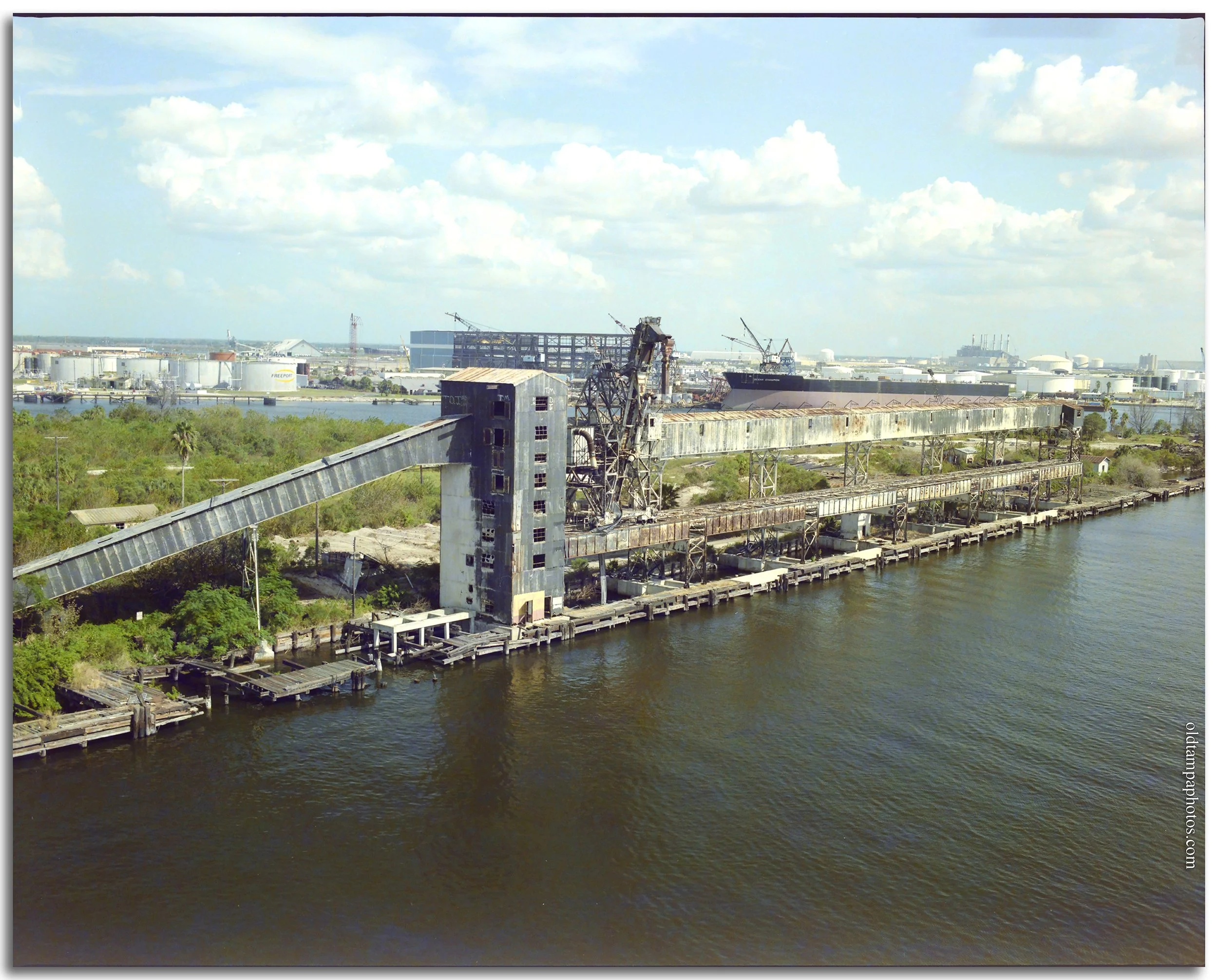 Historic photo of the phosphate elevators on Harbor Island in Tampa during the mid-1980s. The image captures the final years of Tampa's industrial waterfront before Harbor Island's transformation into a residential and commercial community.