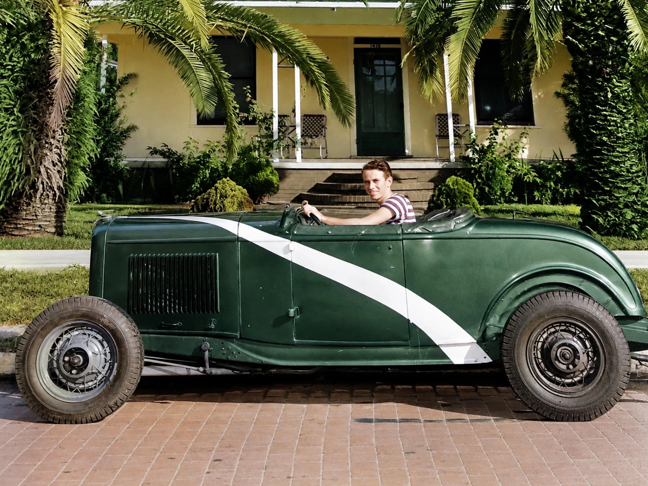 This is Joe Sheppard in 47 shortly after he graduated from Plant High School. The car is a 32 Ford Roadster. Joe built the car from parts he bought from local salvage yards. It was highly modified with a Ardun OHV conversion. He installed a Lincoln Z