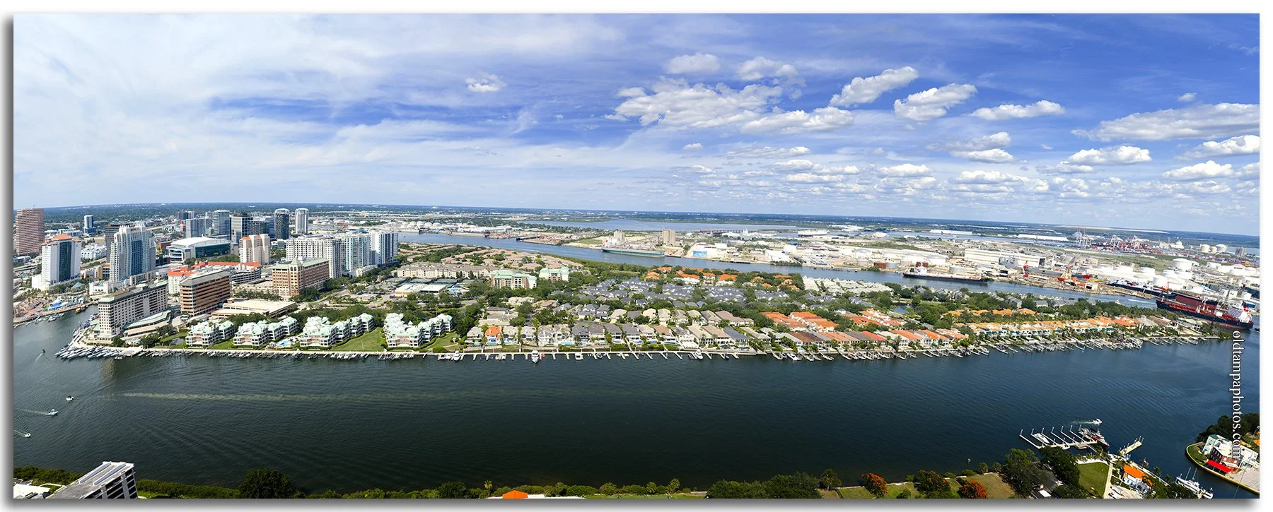 Panoramic aerial photograph of Harbor Island from Davis Islands in 2026, featuring Tampa's waterfront skyline, marinas, residential towers, and the city's evolving urban landscape.