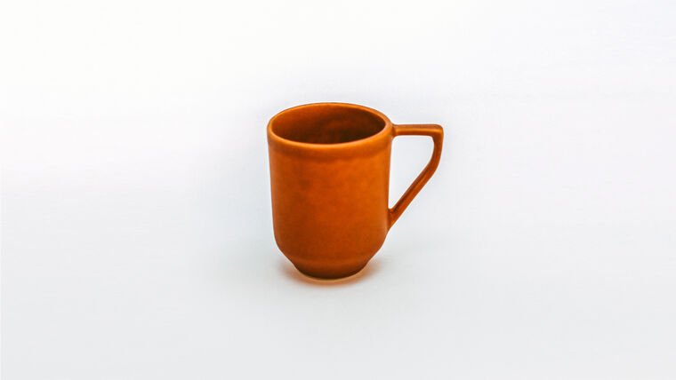 Brown ceramic mug on a white background.