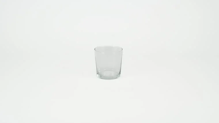 Empty glass tumbler on a white background
