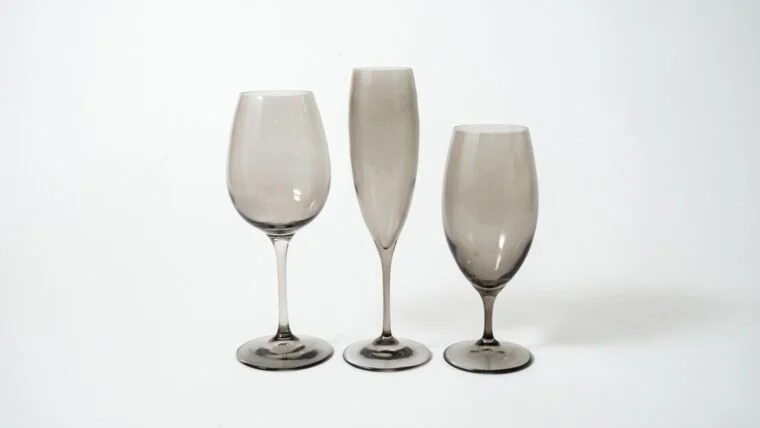 Three empty wine glasses on a plain white background, arranged in a row.