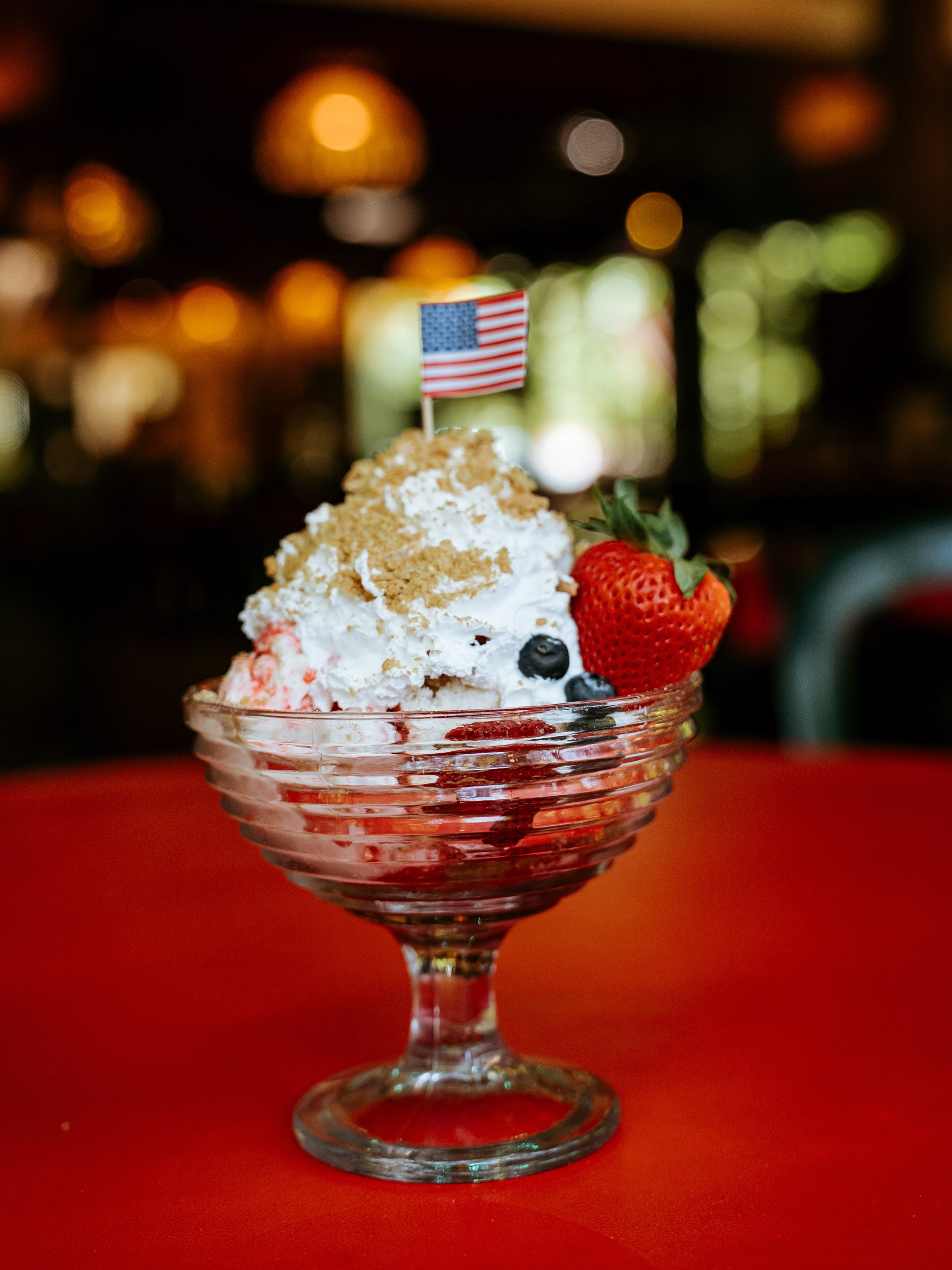 Say hello to the New Sundae of the Month, the BERRY USA!🇺🇸

The Berry USA comes with a slice of cheesecake nestled between two and a half scoops of strawberry cheesecake ice cream topped with strawberry topping, whipped cream, graham cracker crumbs