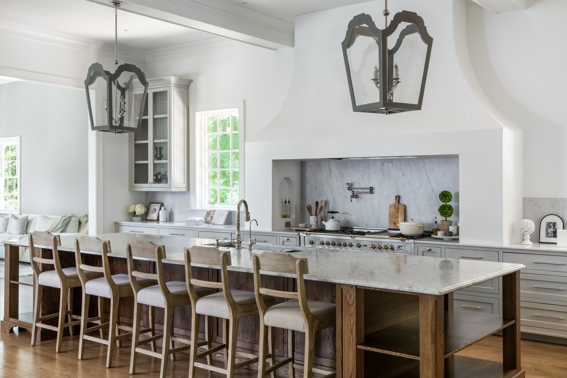 Gourmet kitchen inside Lee Circle renovation—12-foot marble waterfall island, integrated Sub-Zero refrigeration, and concealed walk-in pantry.