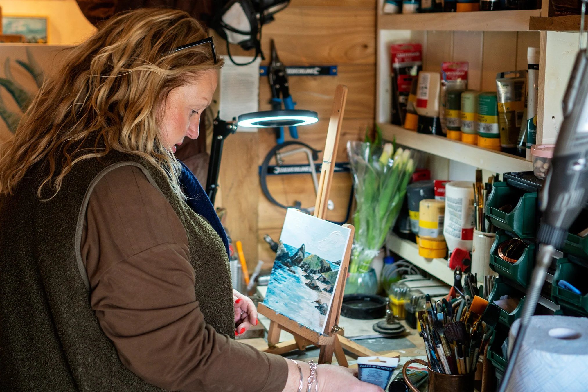 artist stacey sibley painting in her studio in port isaac