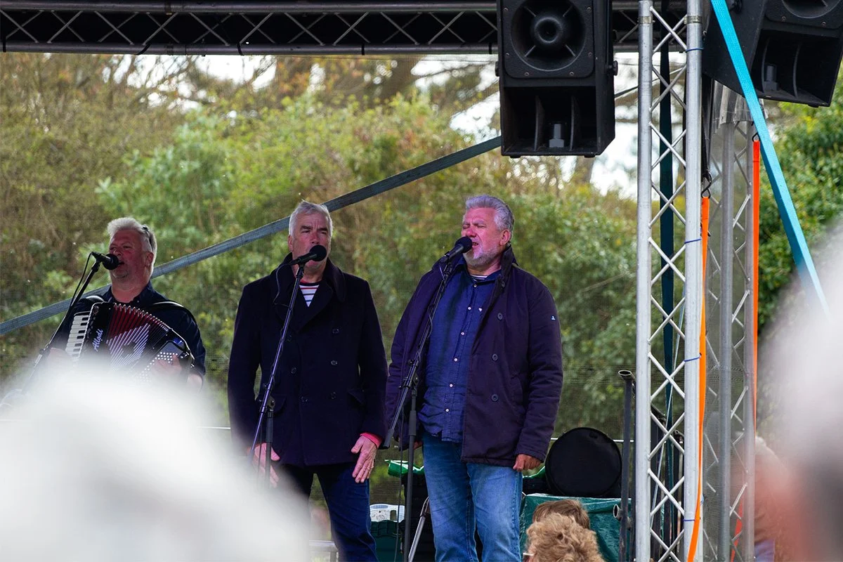 the fisherman's friends singing at the port isaac shanty festival in 2024