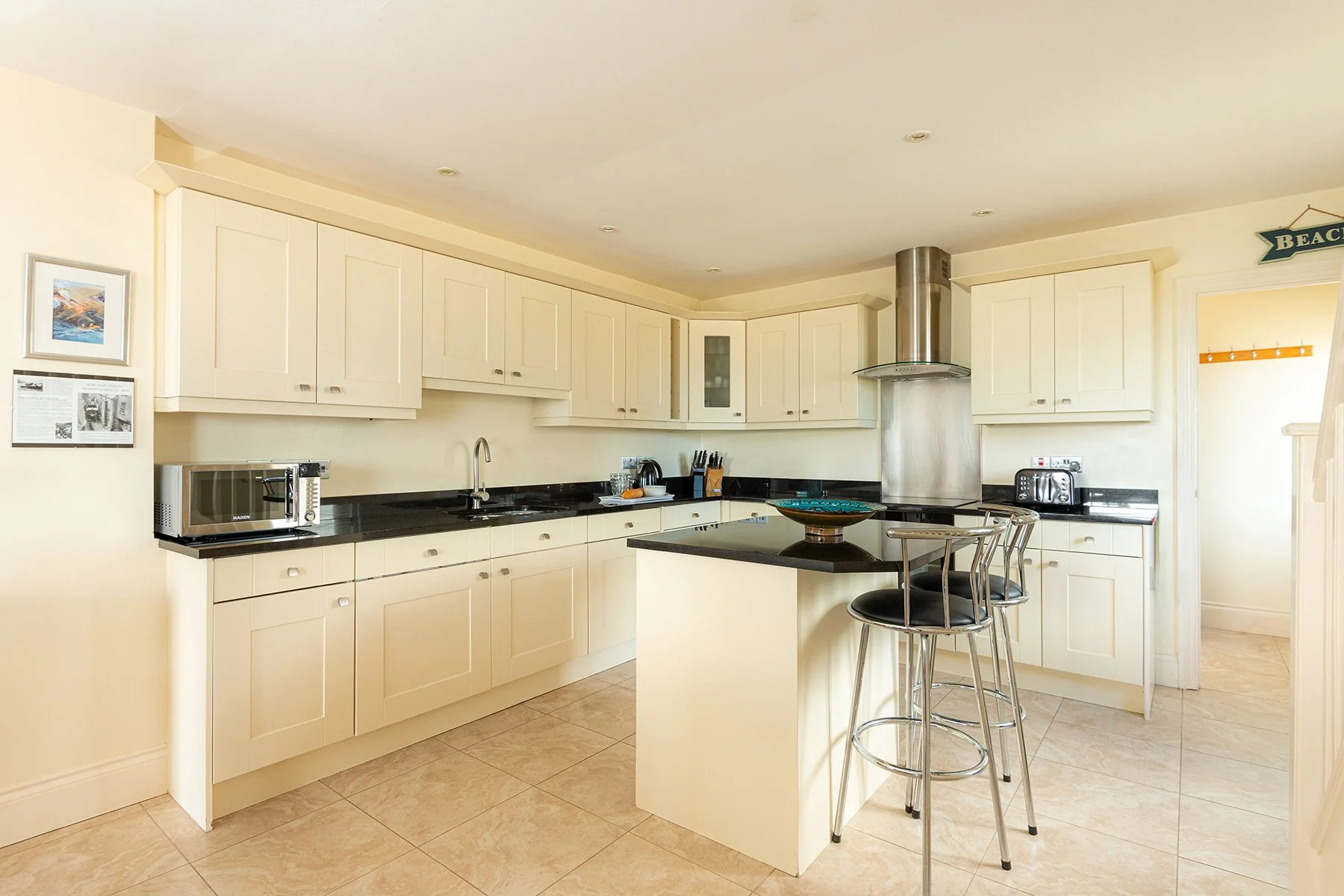 modern cream coloured kitchen with black worktops at sea gems