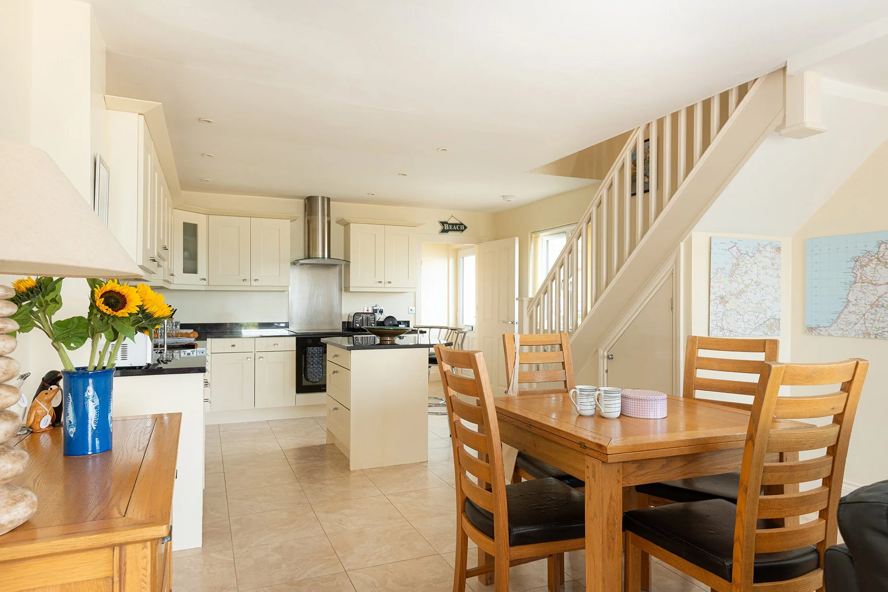 the kitchen dining area t sea gems with a vase of sunflowers on a sideboard
