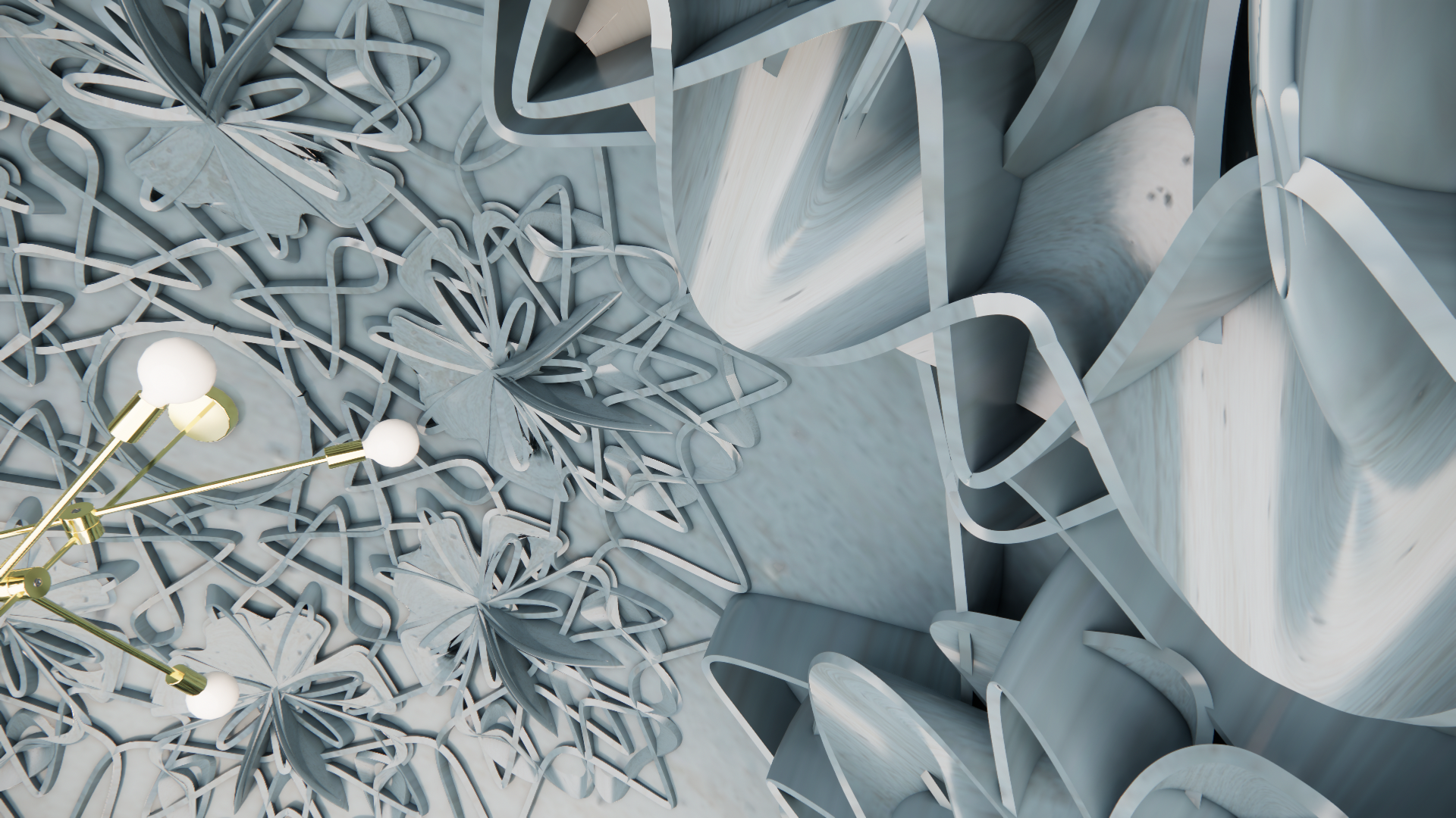 Detail of a modern, artistic white marble sculpture with intertwined floral and abstract shapes, and a gold chandelier with white globes.