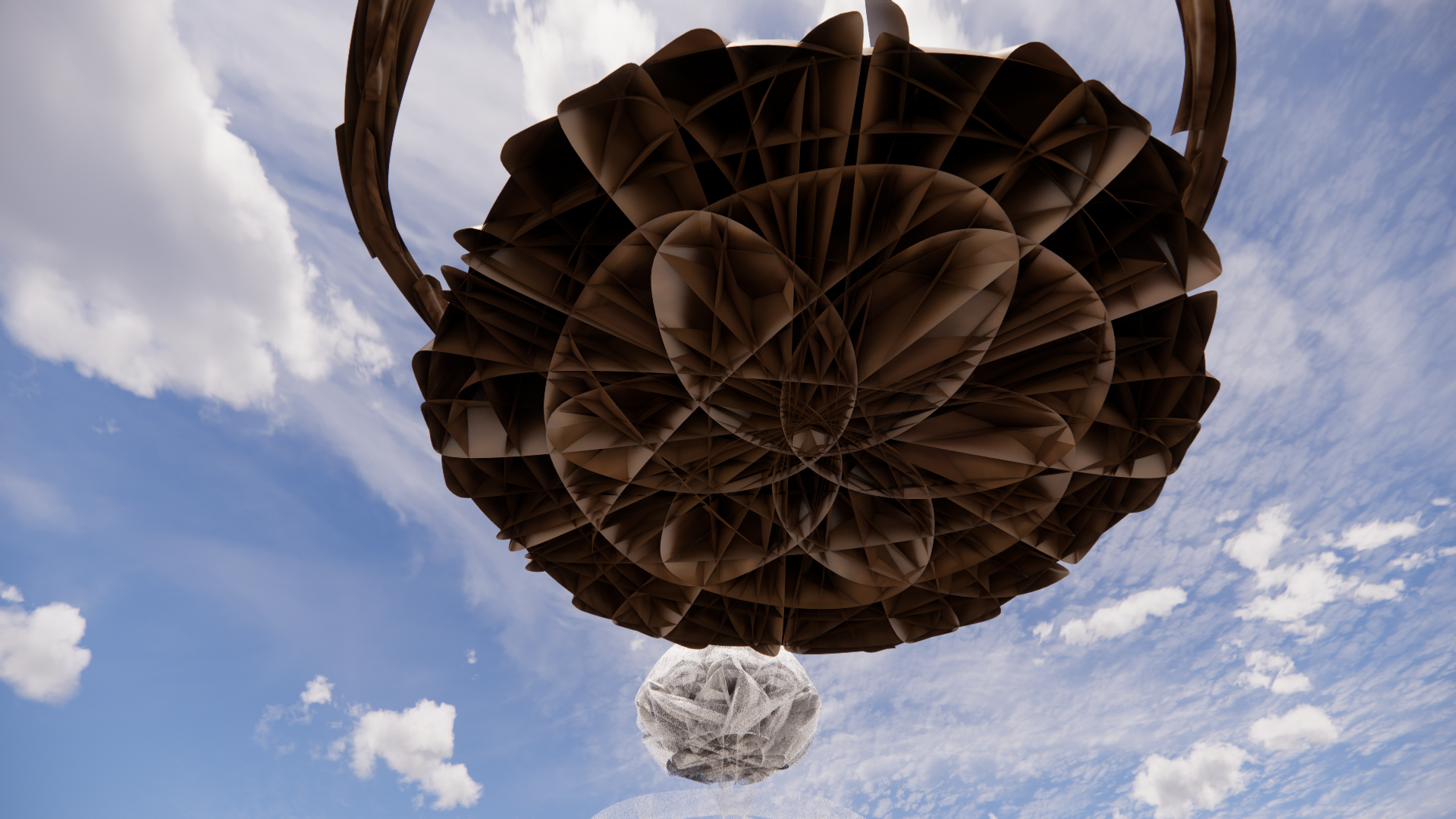 A large paper lantern with an intricate, folded design is floating in the sky against a partly cloudy backdrop, with a small white paper bag attached at the bottom.