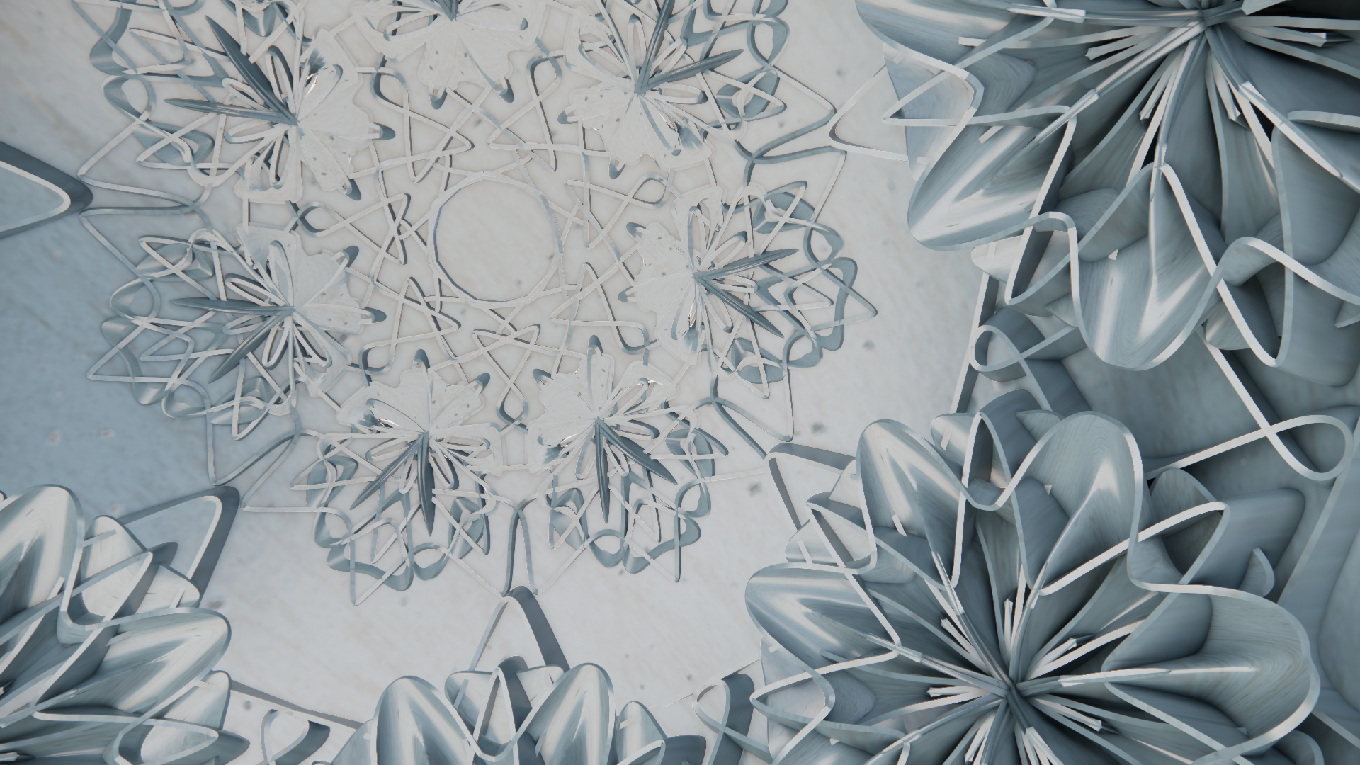 Metallic snowflakes and heart-shaped decorations arranged in a circular pattern on a white surface, possibly for a holiday display.