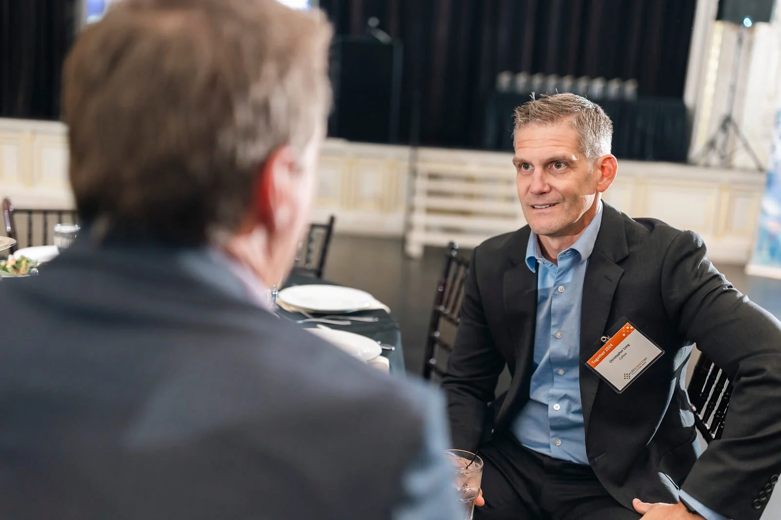 Two people chatting at the Life Science NY Event in 2024 at the Harro East Ballroom