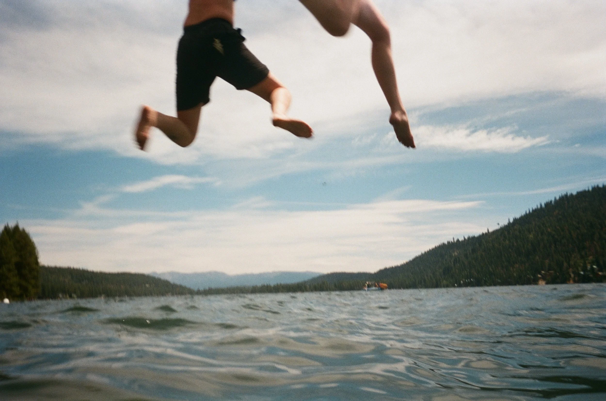 My personal fave. The last image on a waterproof disposable film camera, shot in one take. I was treading water in the lake and had my friends jump off the dock over me
