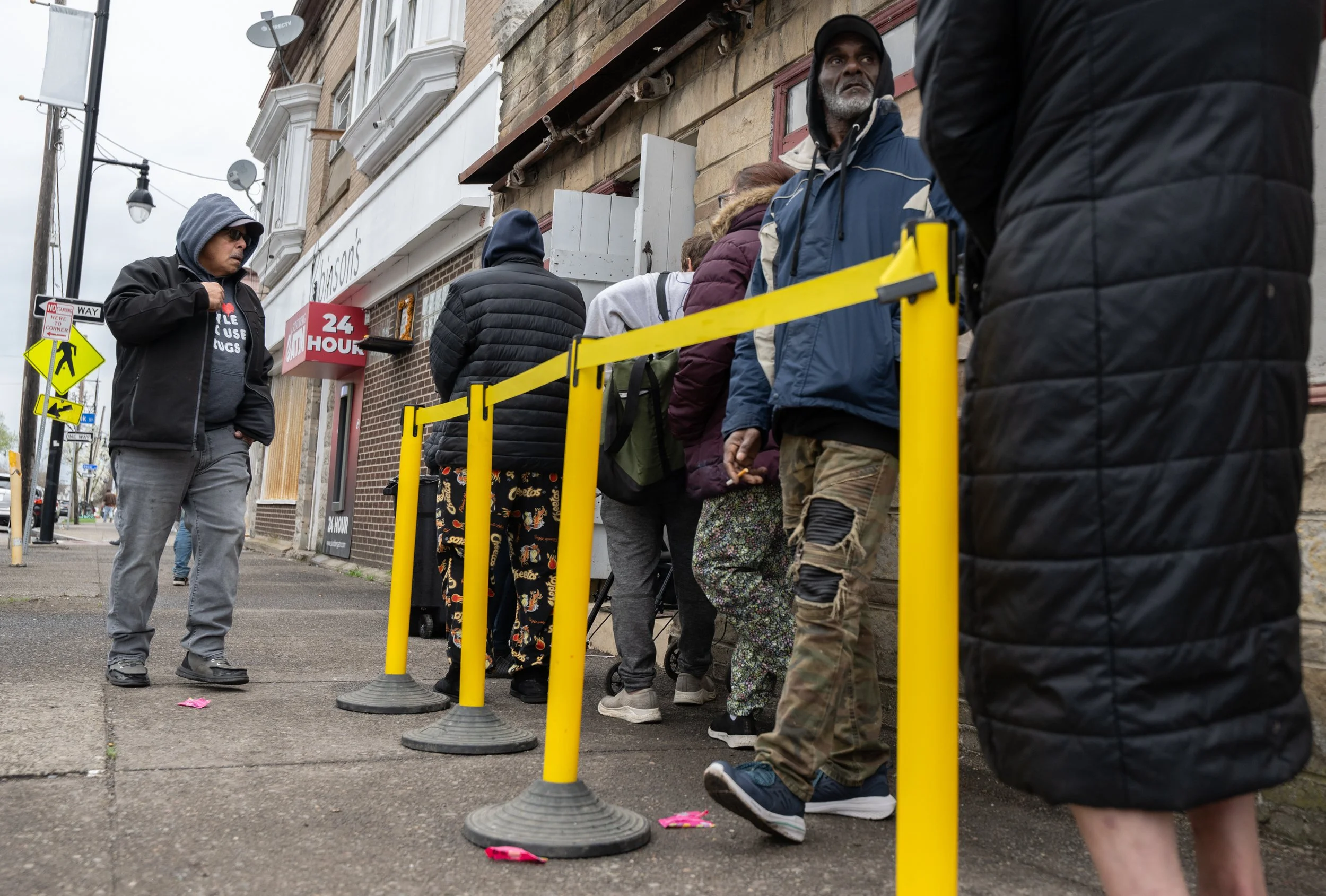 Stephen Rosa talks with people awaiting services at RAW during their outreach on April 19, 2026.