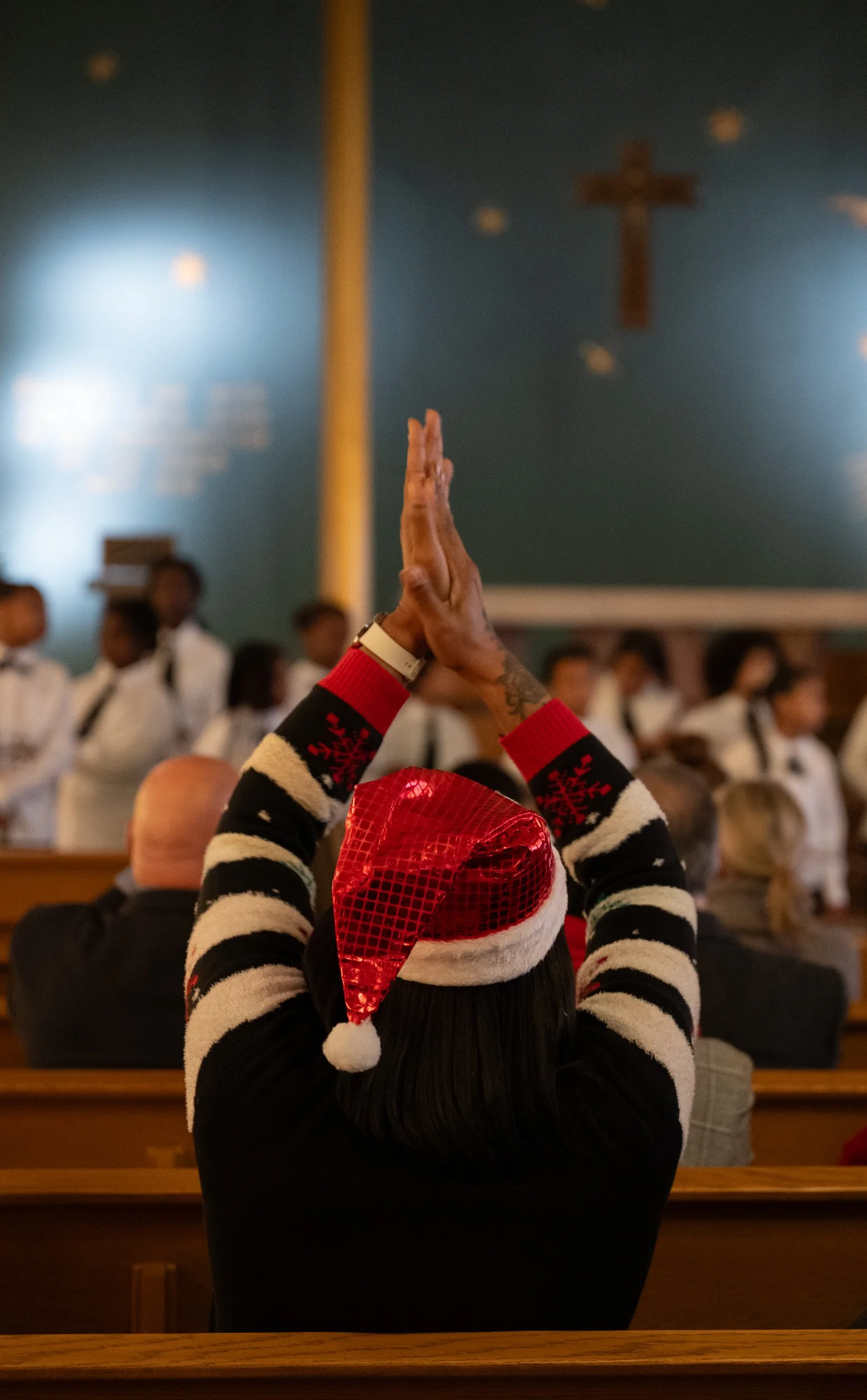 Evonne Cochran reacts to the "Strings for Success" performance during the 2025 National Homeless Persons’ Memorial Day event at the St. Mary’s Campus Chapel on Dec. 18, 2025. Cochran is a housing stability coordinator for PCHO.