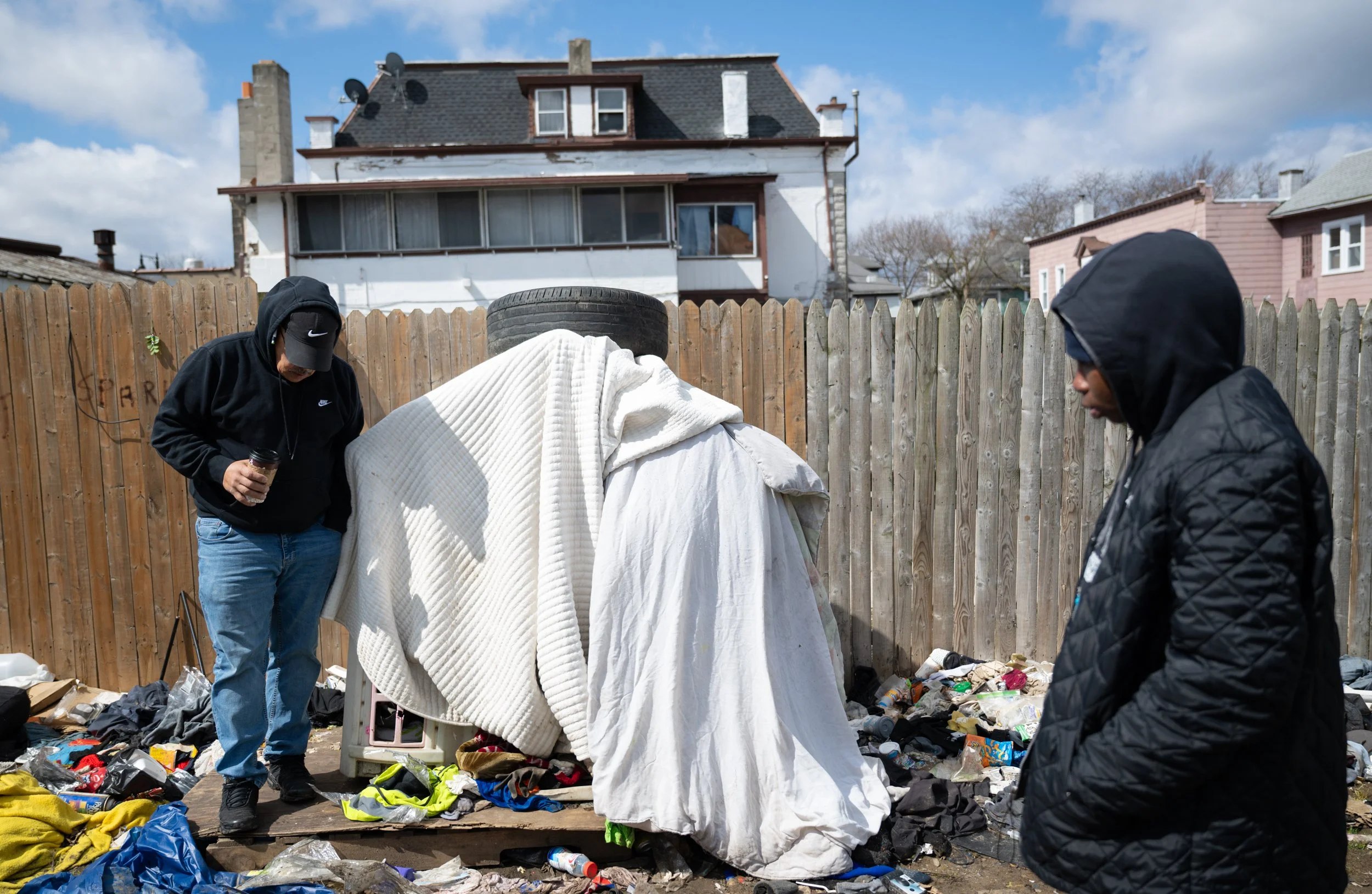 Stephen Rosa talks with an unhoused man named Cody through his sleeping arrangement during PCHO outreach in on April 6, 2026. Cody lives in a children's outdoor playhouse behind RAW and has a habit of accumulating clothes and garbage around the area.