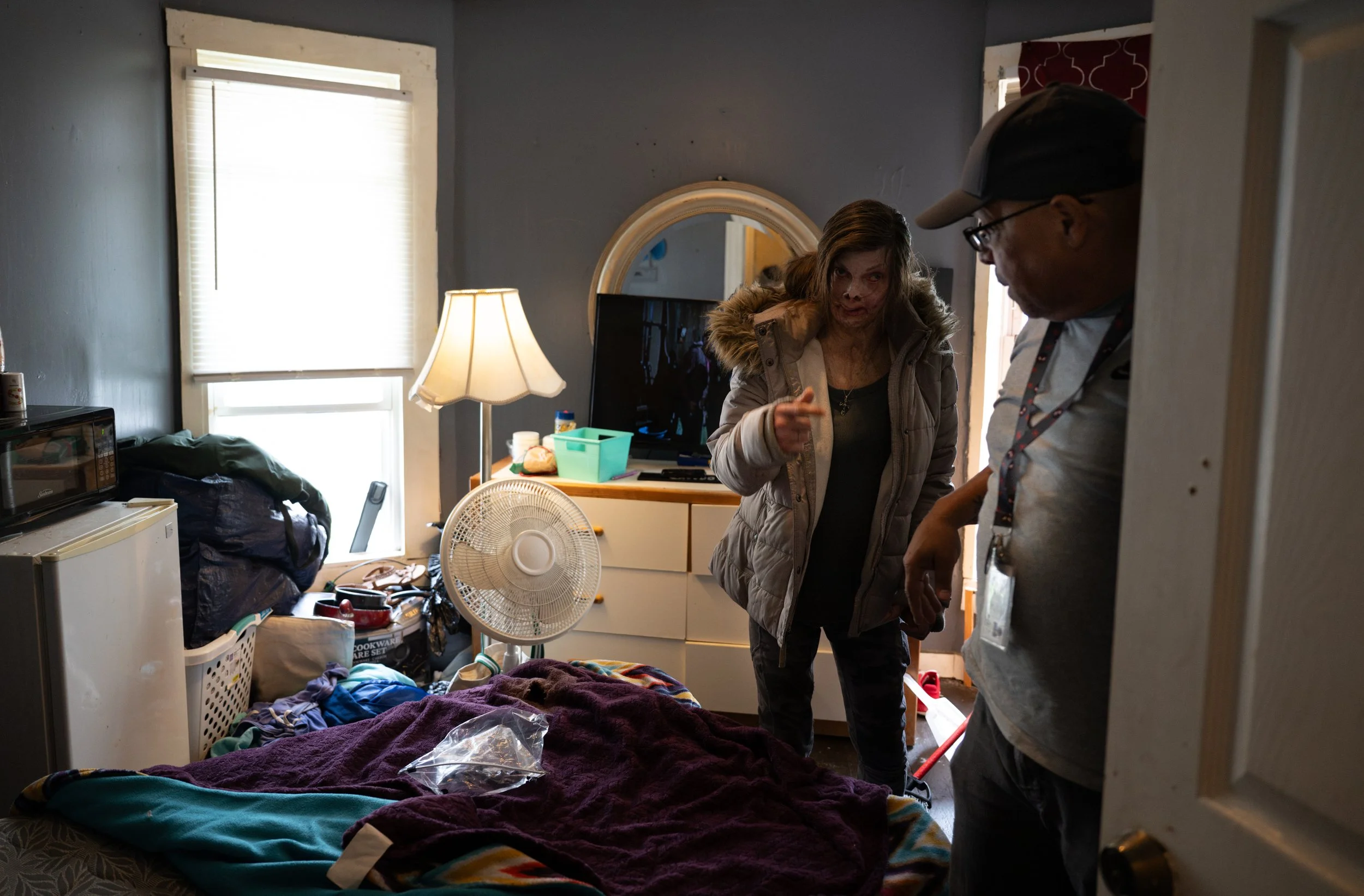 Stephen Rosa talks with Robin Carpenter in her room after helping her carry in food and groceries at her house on April 17, 2026.