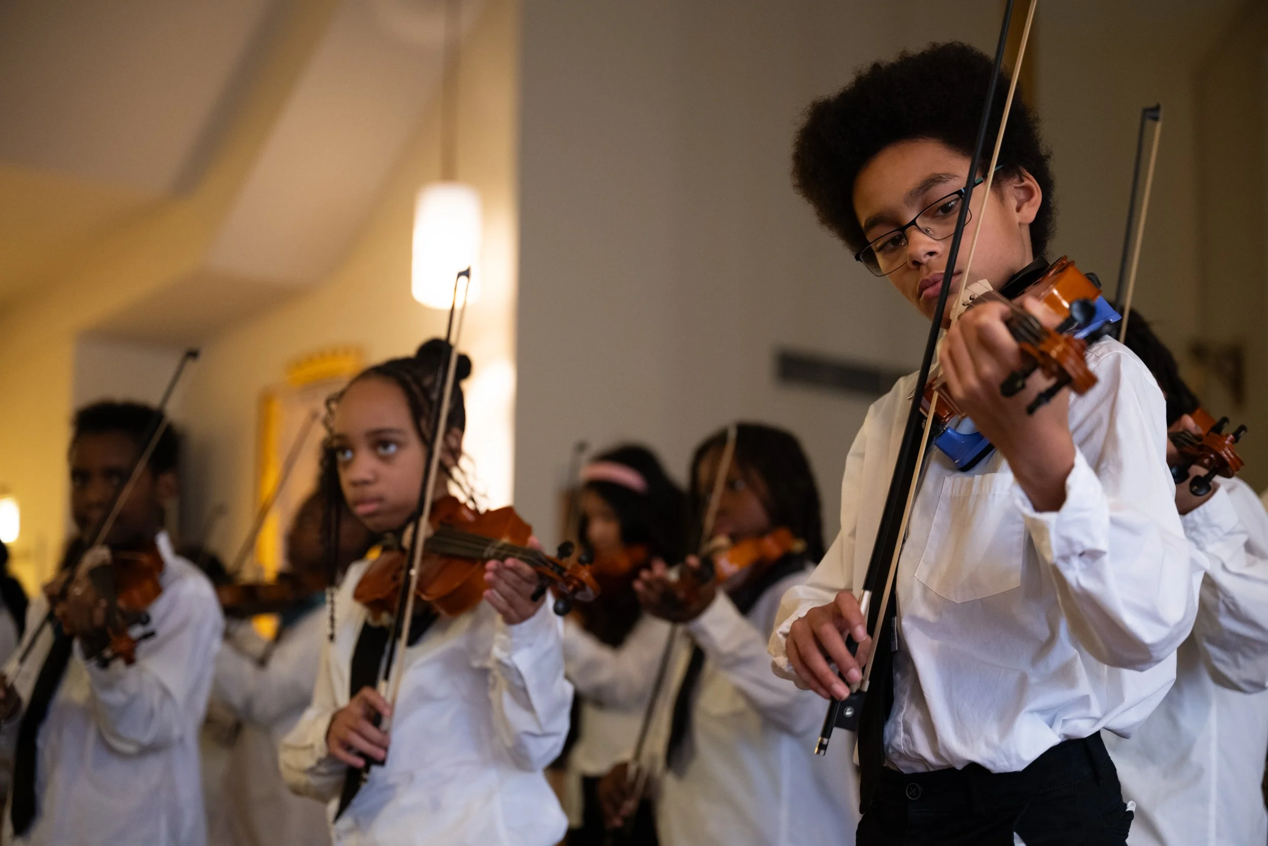 Members of "Strings for Success" from the Center for Youth play violin during the 2025 National Homeless Persons’ Memorial Day event at the St. Mary’s Campus Chapel on Dec. 18, 2025. Strings for Success operates on the belief that "all children shoul