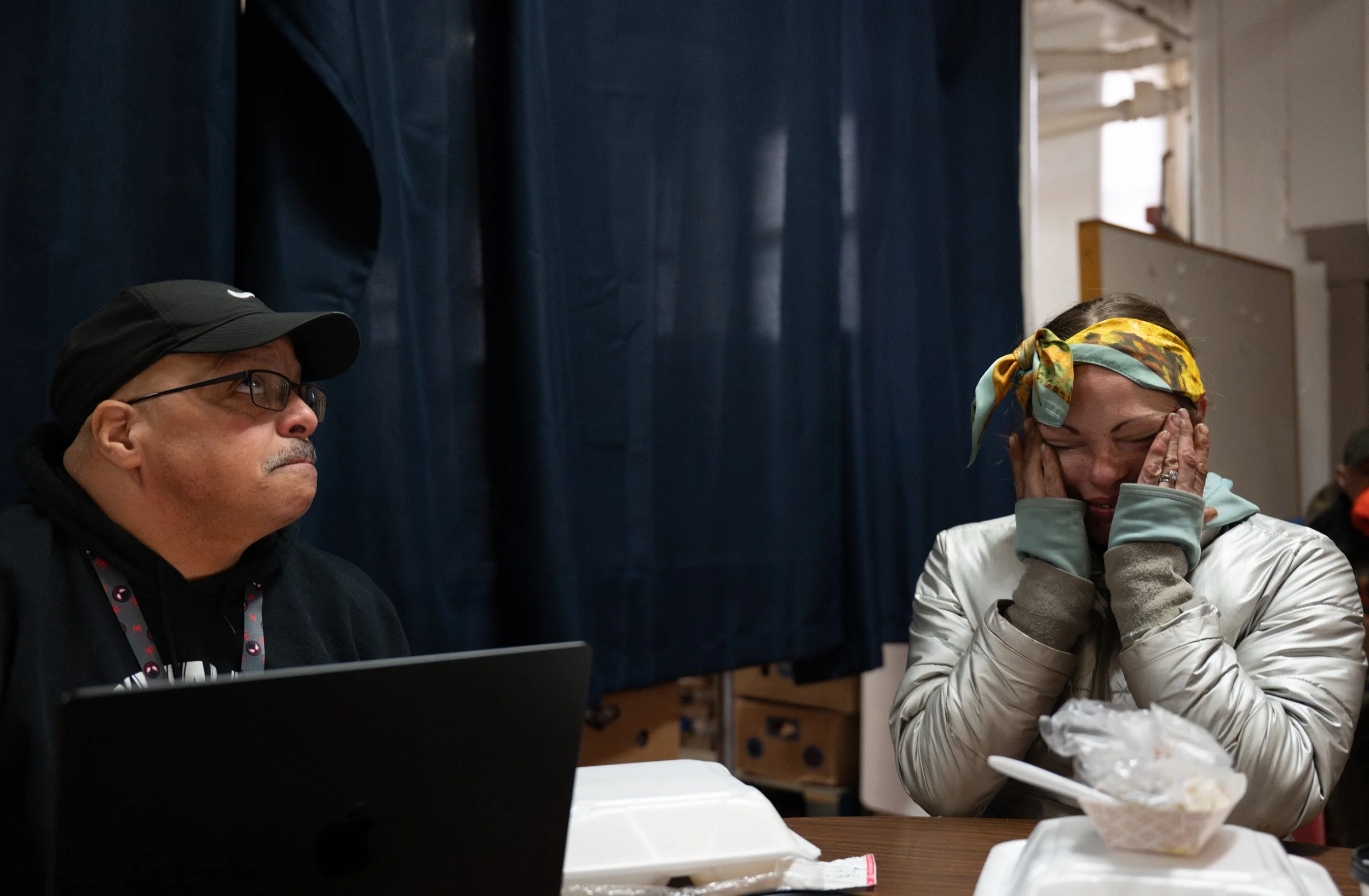 Stephen Rosa comforts new client Jenna Salamone after she began crying when asked about her son at St. Peters kitchen on March 12, 2026. Salamone has been unhoused for a year in a half after her landlord let the property become inhabitable and the ci