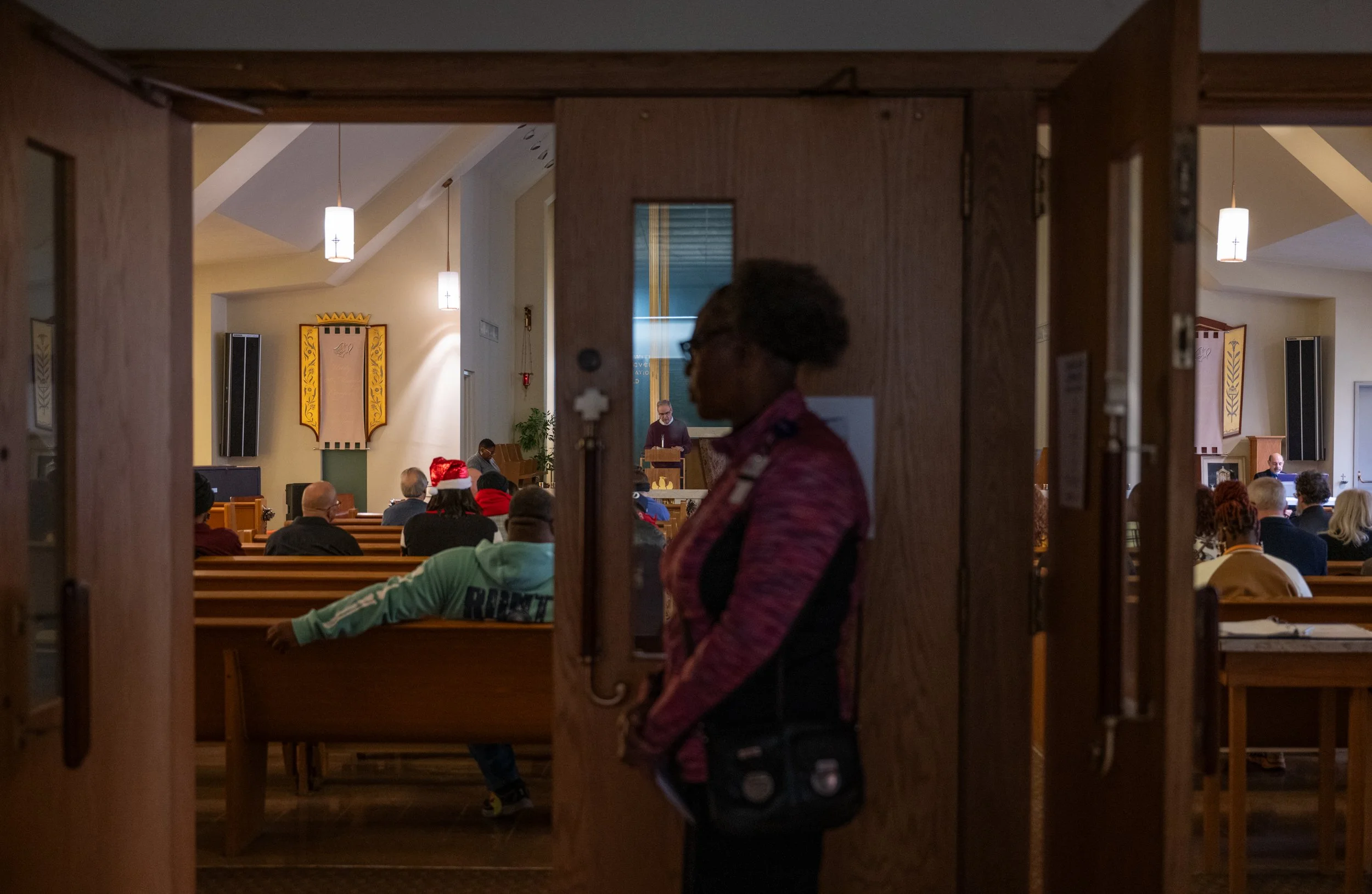 Health Reach social worker Kim Allen watches the 2025 National Homeless Persons’ Memorial Day event at the St. Mary’s Campus Chapel on Dec. 18, 2025. 
