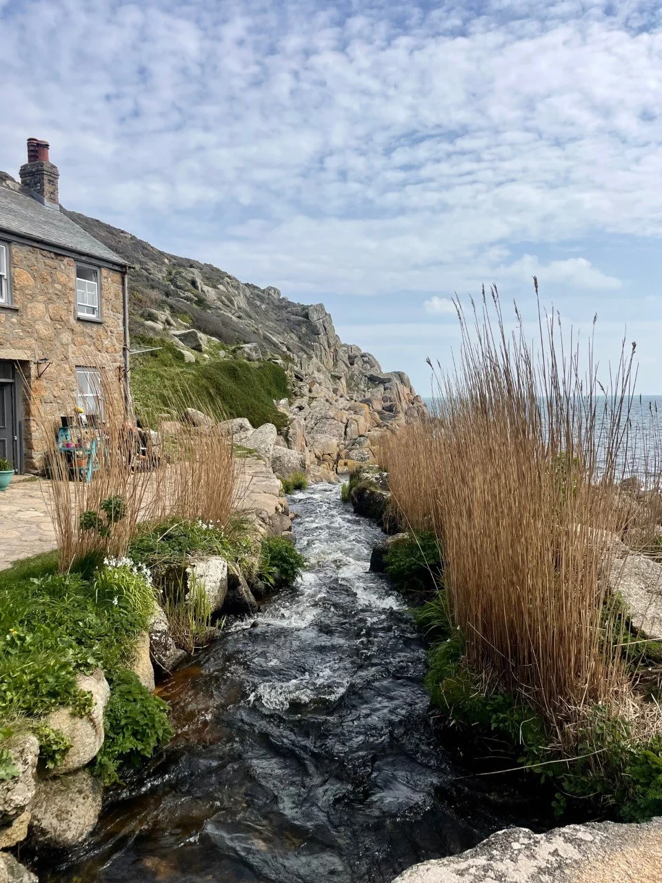 Close-up of stream running alongside house in a Cornish cove