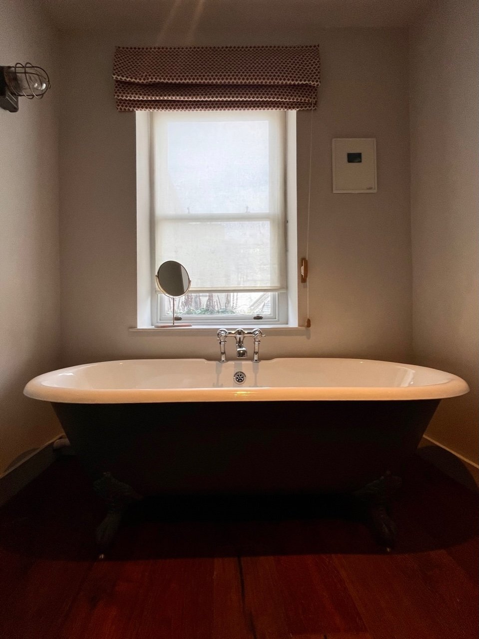Roll top bath tub and window