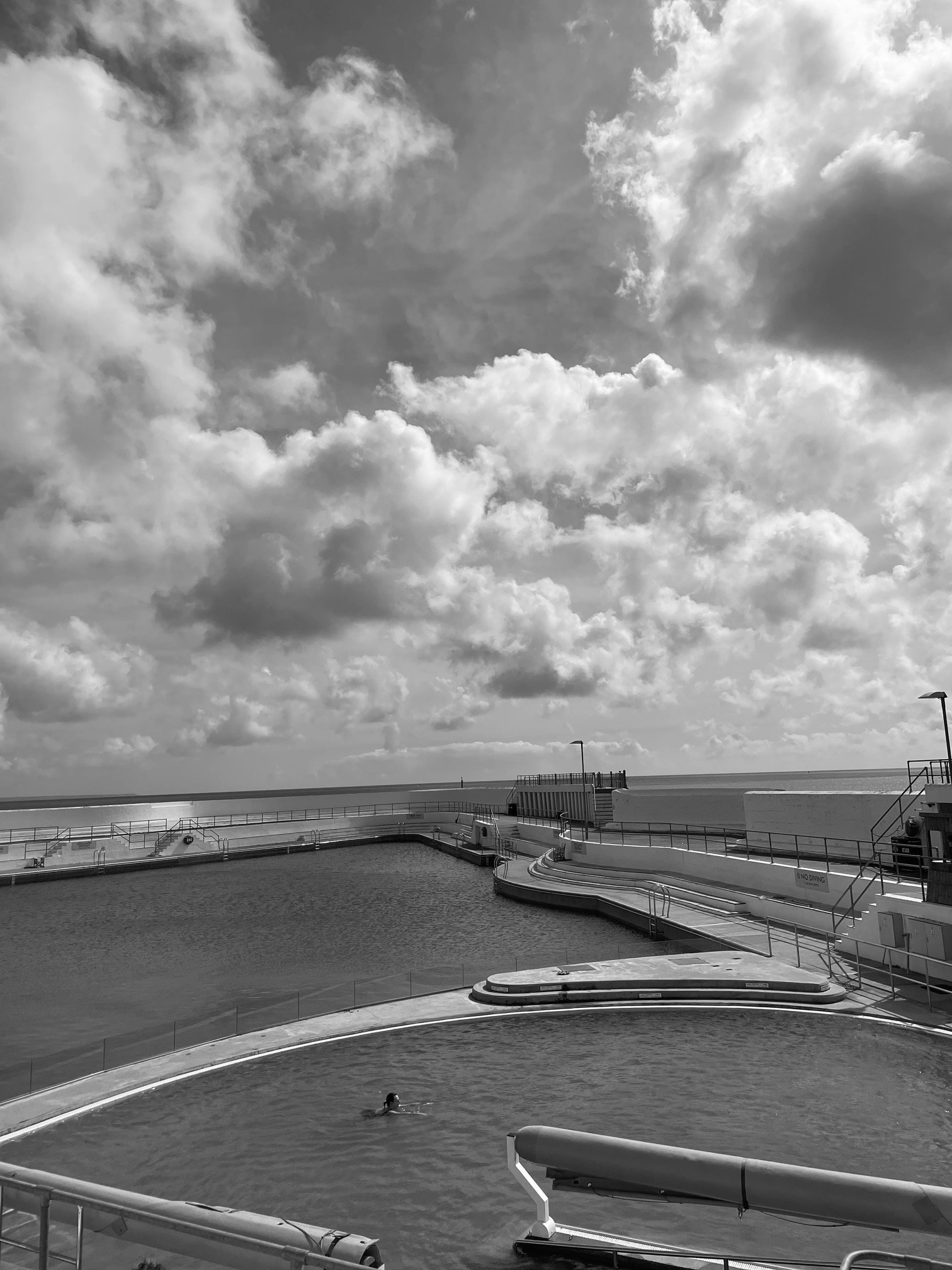 Lady swimming alone in the Lido