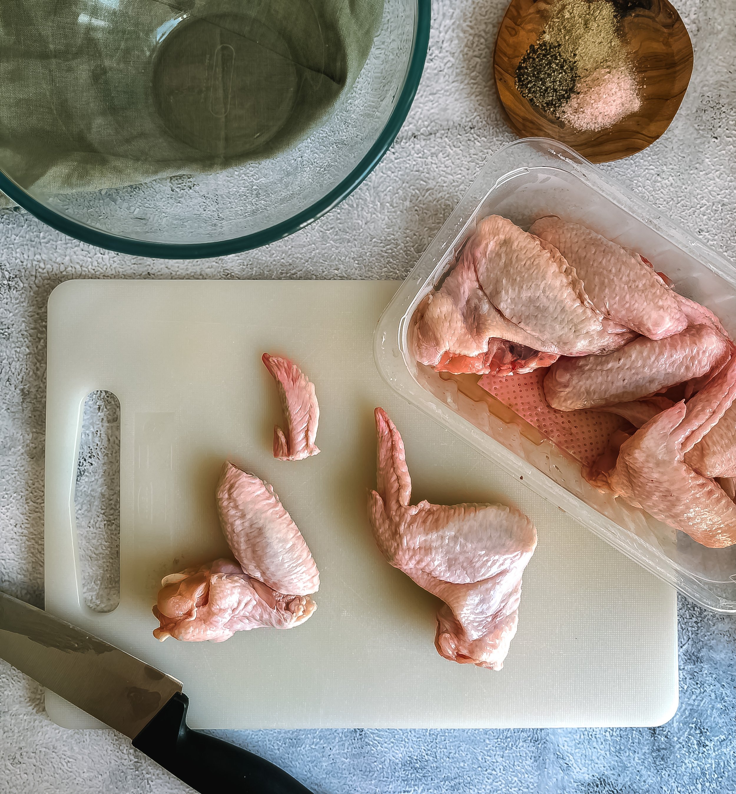 Raw chicken wings arranged neatly on a clean cutting board. Fresh and ready for flavorful preparation. A versatile ingredient for creating mouthwatering BBQ chicken wings. Get ready to transform these raw wings into a delicious culinary masterpiece.