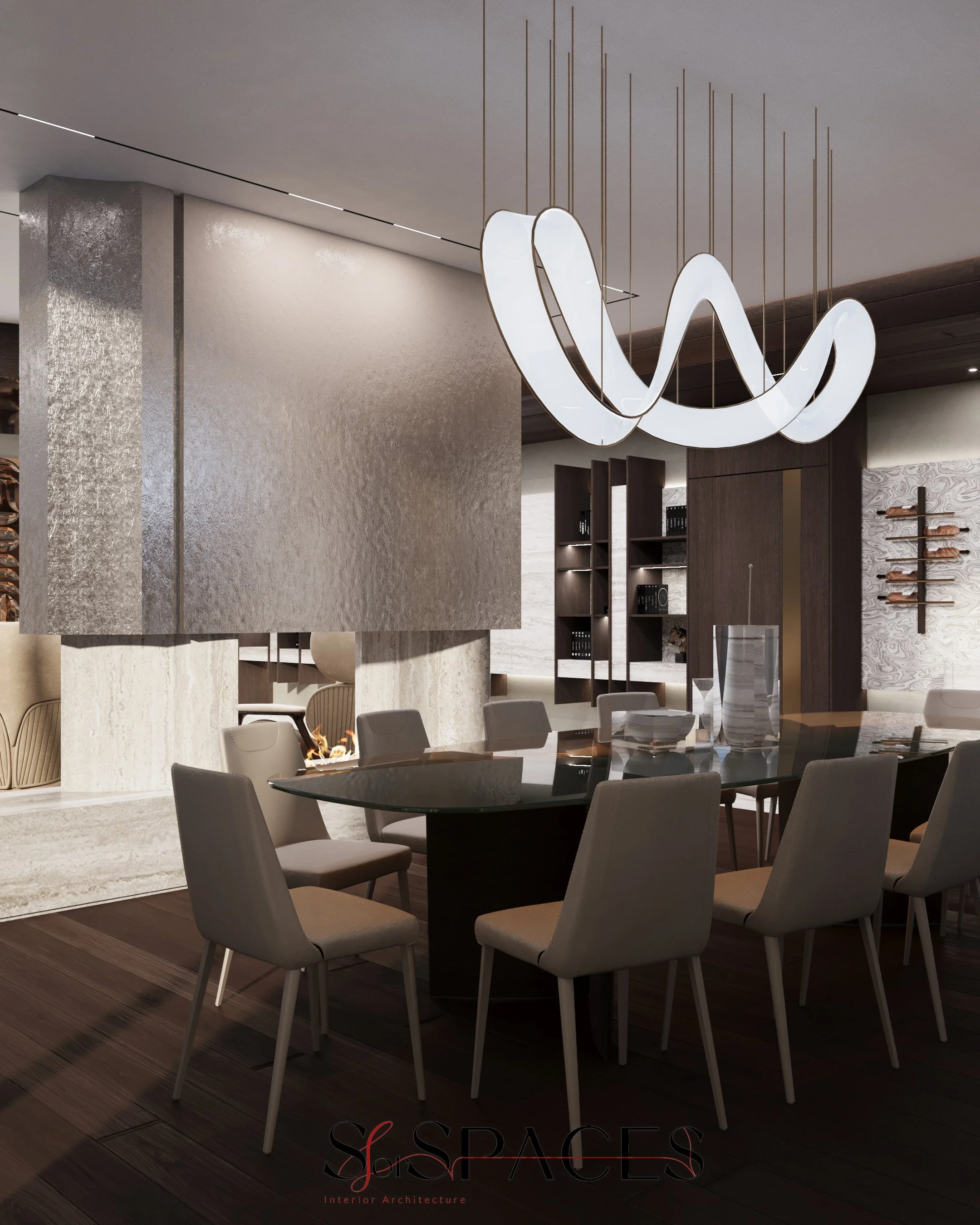 The dining area is defined by a suspended textured architectural fireplace. Acting as a semi-transparent visual divider, this element creates a sense of intimacy for the dining zone while preserving depth and continuity towards the living area beyond