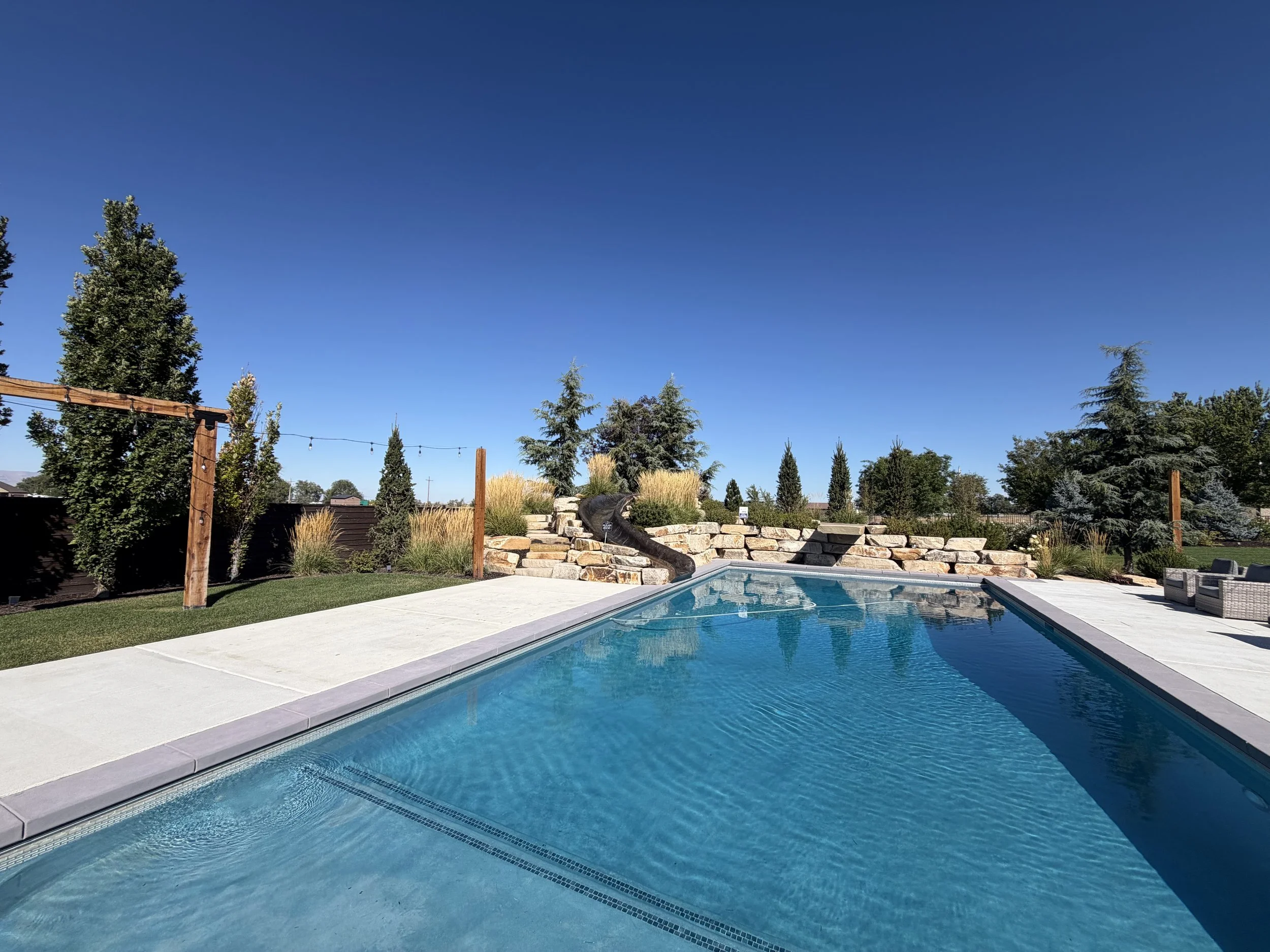alecia-lewis-backyard-pool-stone-wall.jpg.jpeg