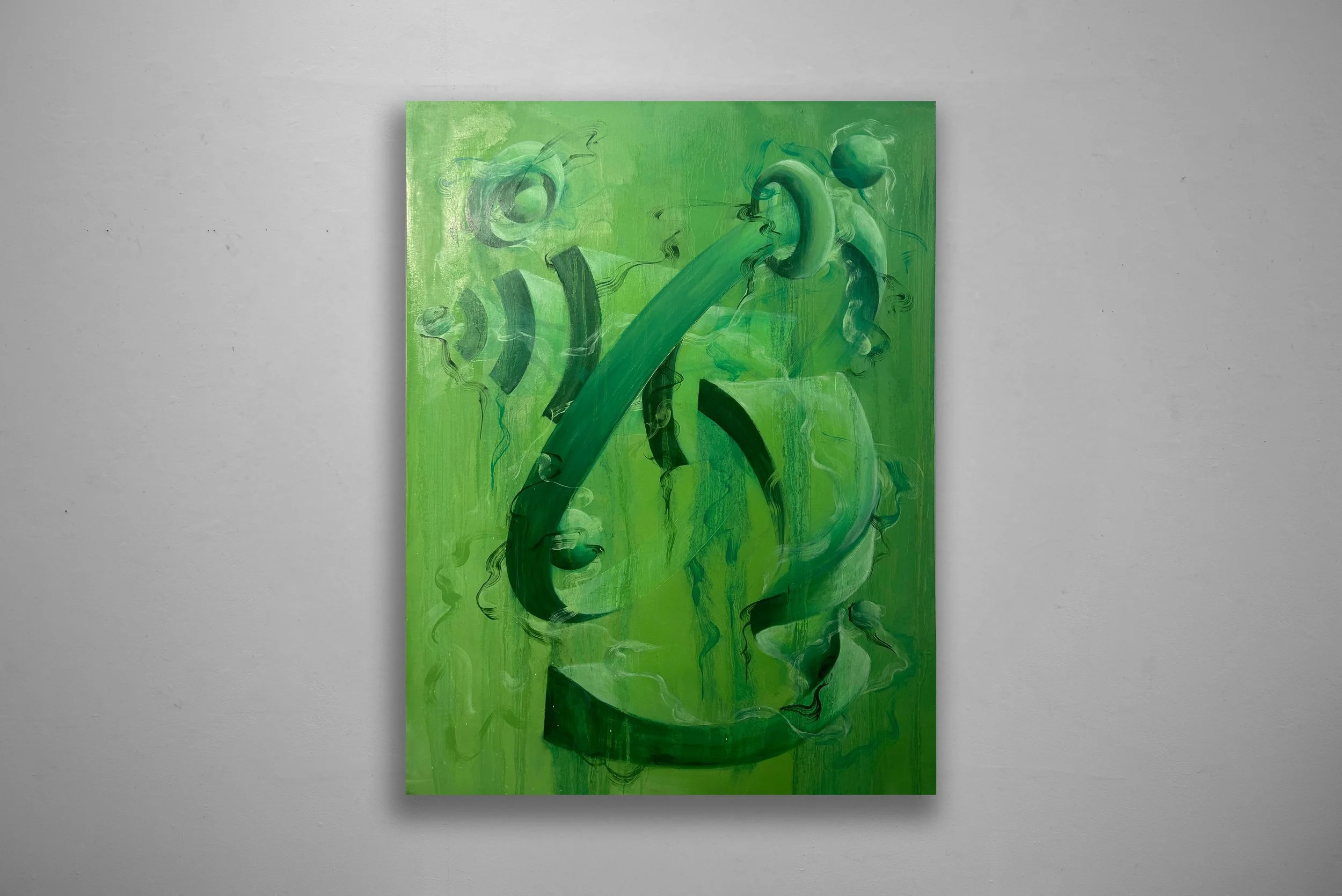 Green abstract painting with swirling shapes and bold brushstrokes on a rectangular canvas hung on a plain gray wall.