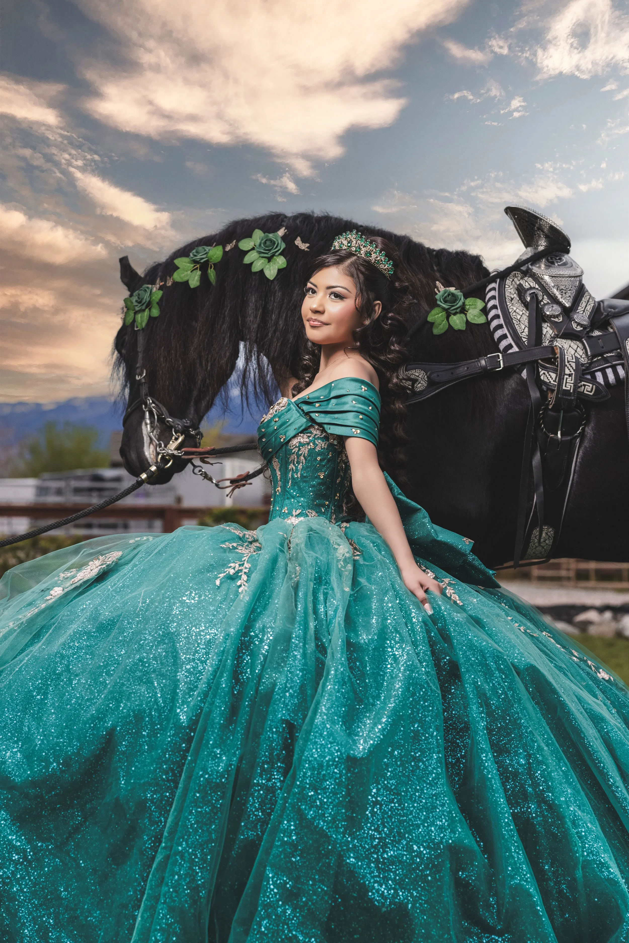 Elegant quinceañera photography at Rancho La Gloria in Utah with a black horse, luxury emerald dress, and a dramatic sunset background.