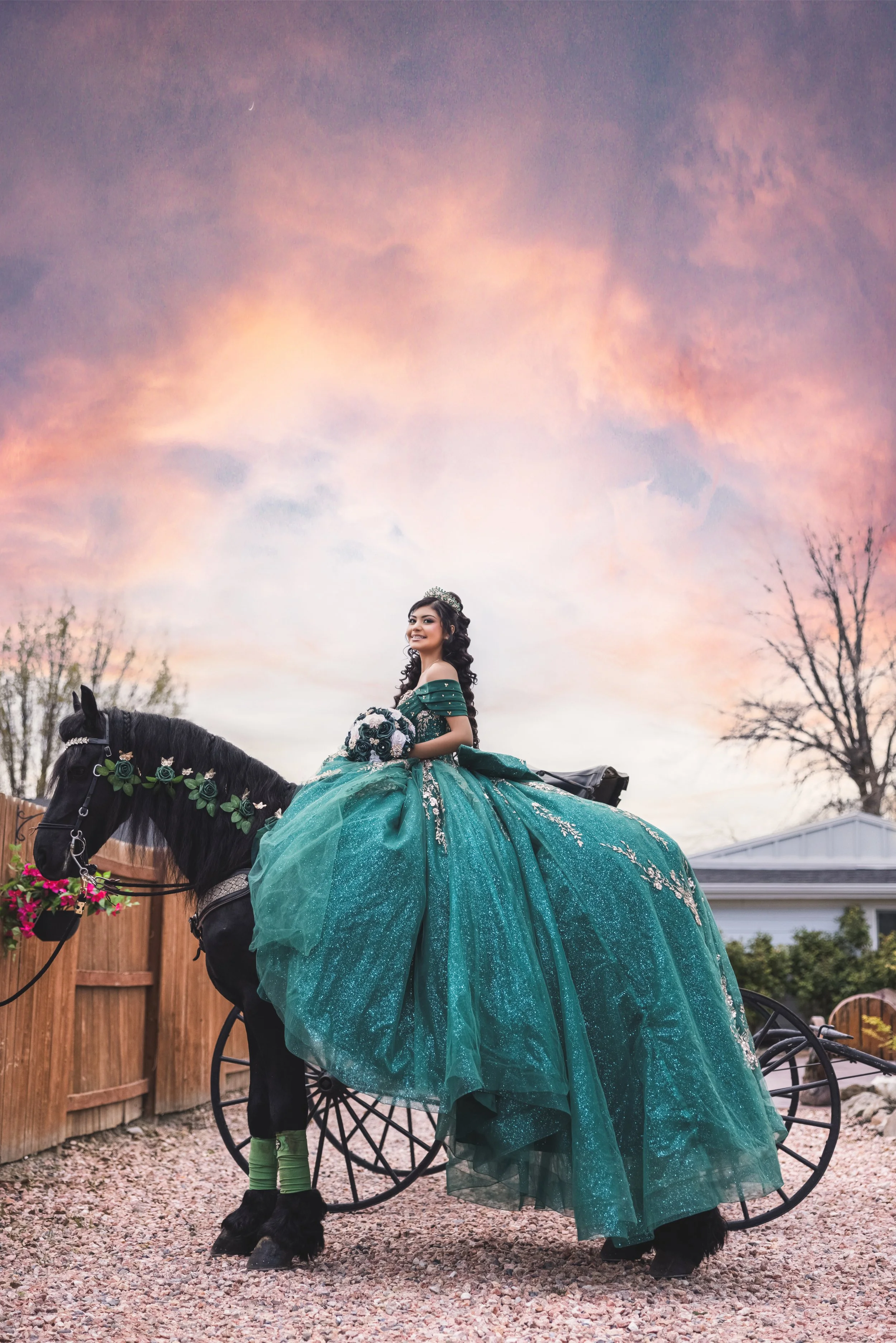 A cinematic quinceañera portrait at Rancho La Gloria in Utah featuring a horse carriage look, emerald quince dress, and soft sunset colors.