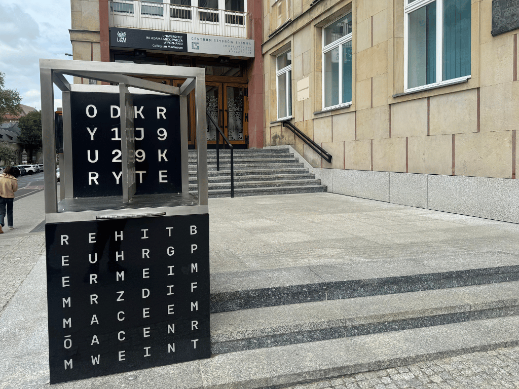 The exterior of the The Enigma Cipher Centre in Poznan, Poland with signage that looks like a cipher
