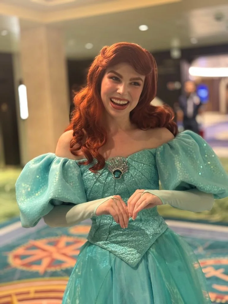 Princess Ariel smiling as she greets guests on Disney Adventure