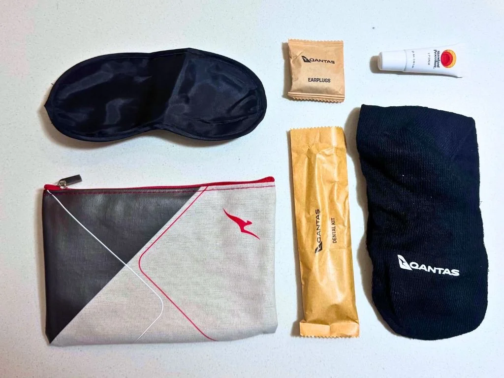 Eye mask, earplugs, lip balm, pencil case, dental kit and socks in the Qantas Premium Economy kit