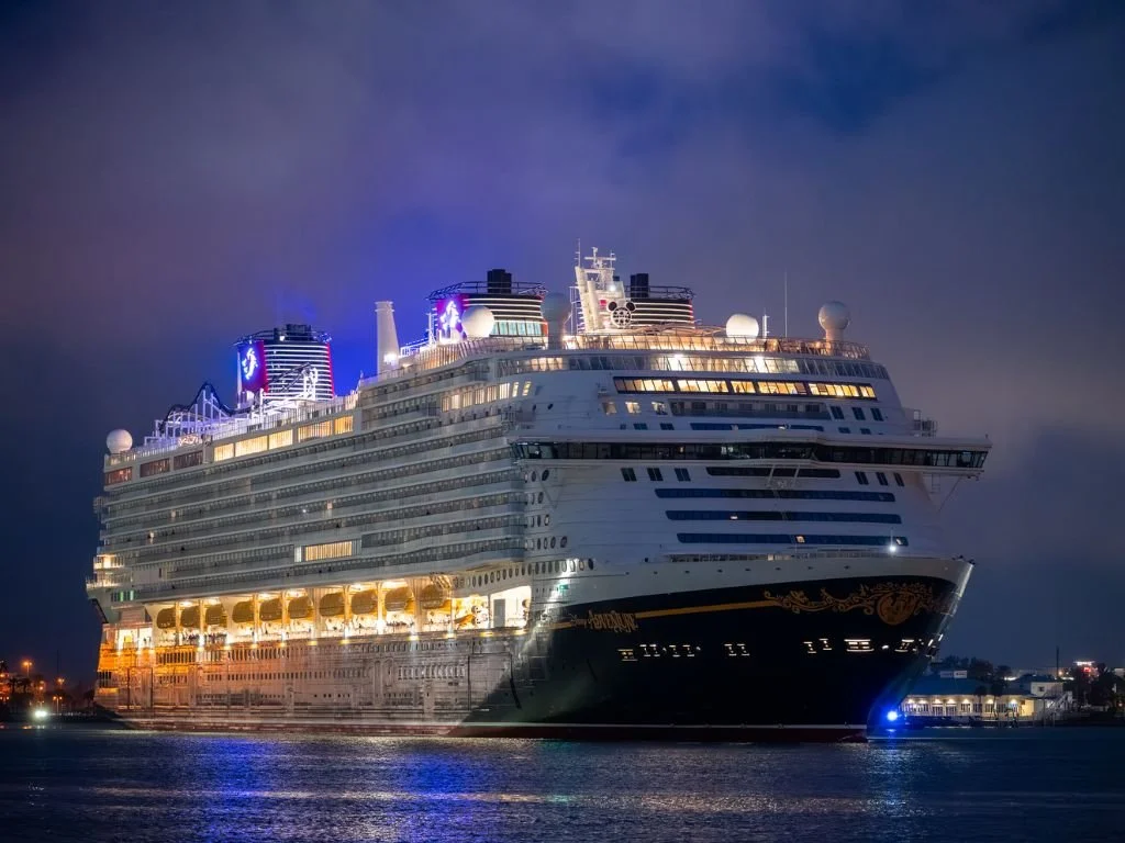 The Disney Adventure lit up at night arrives in Port Canaveral, FL ahead of its journey to Singapore.